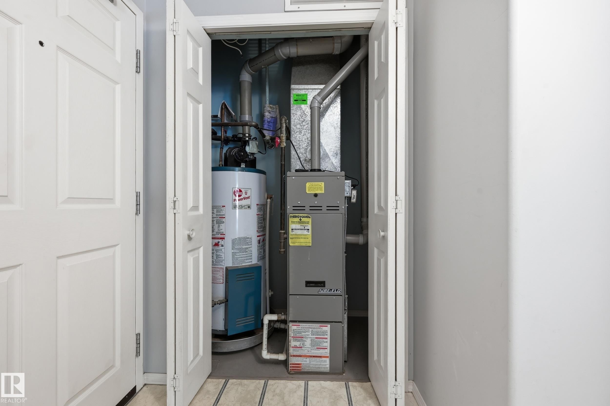 Dedicated utility closet containing a hot water heater and furnace system - 203 11103 84 Avenue, Edmonton, AB