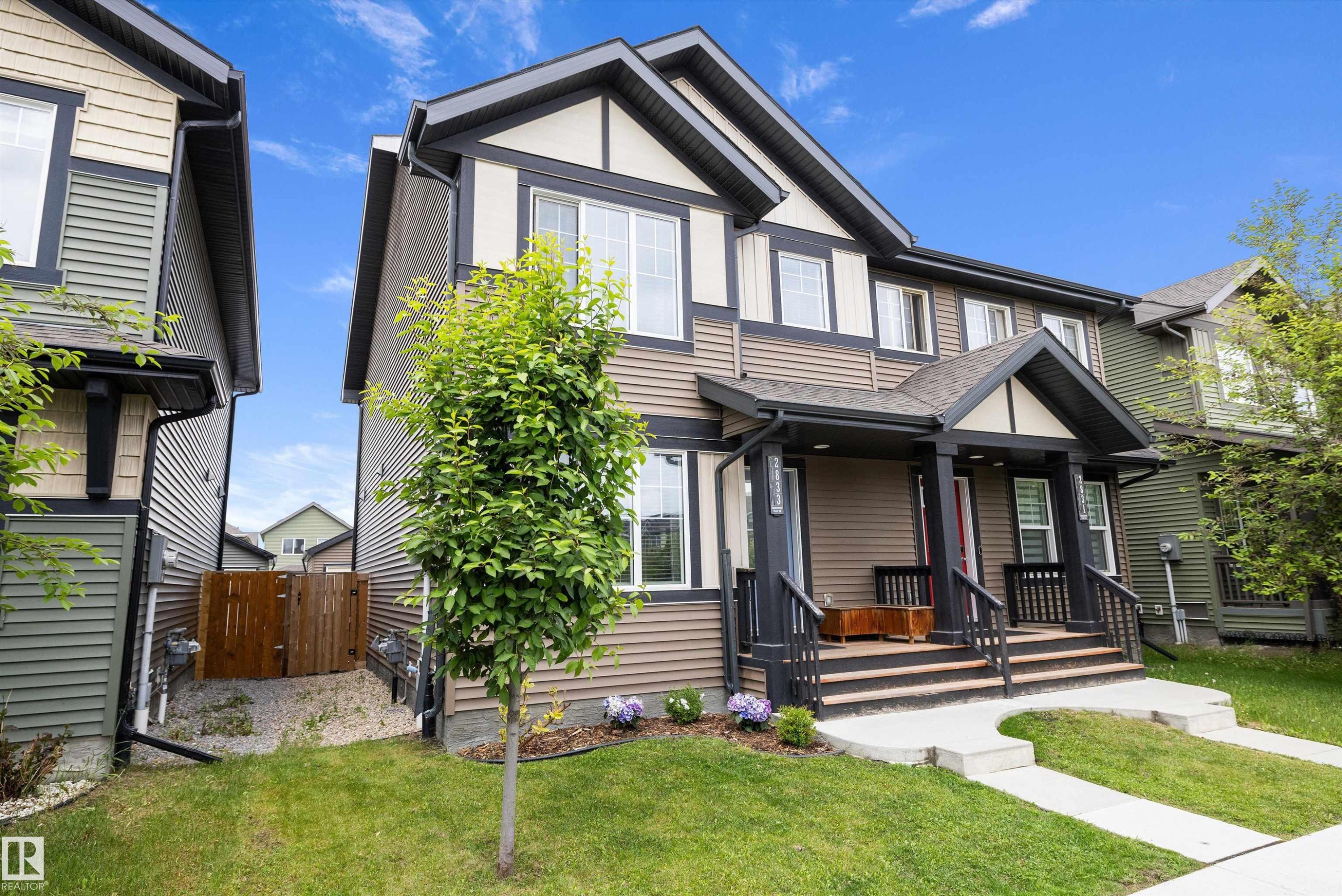 Contemporary two-story residence featuring a covered front porch with dark trim - 2833 Chokecherry Place, Edmonton, AB