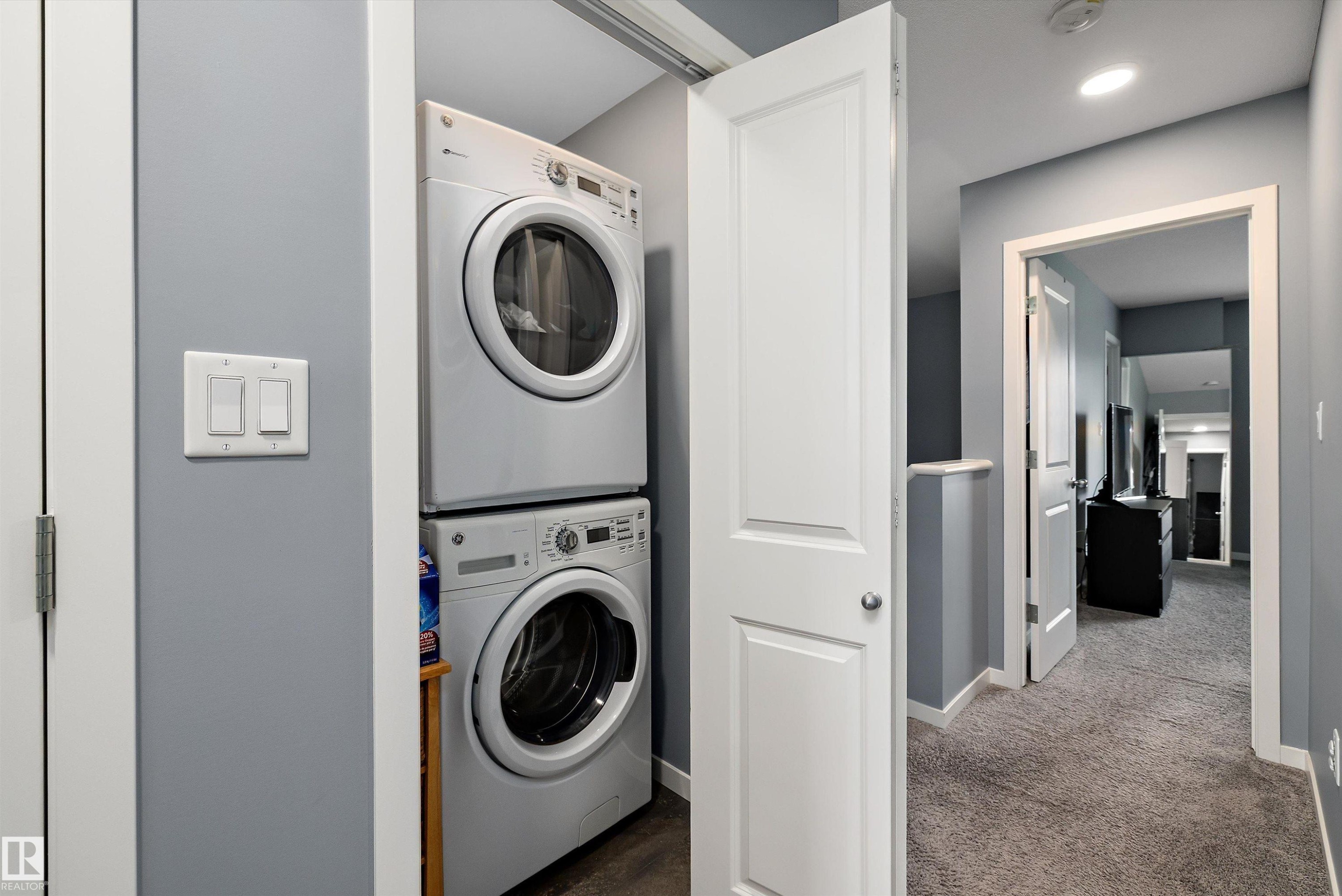 Dedicated laundry area featuring a stacked washer and dryer unit - 2833 Chokecherry Place, Edmonton, AB