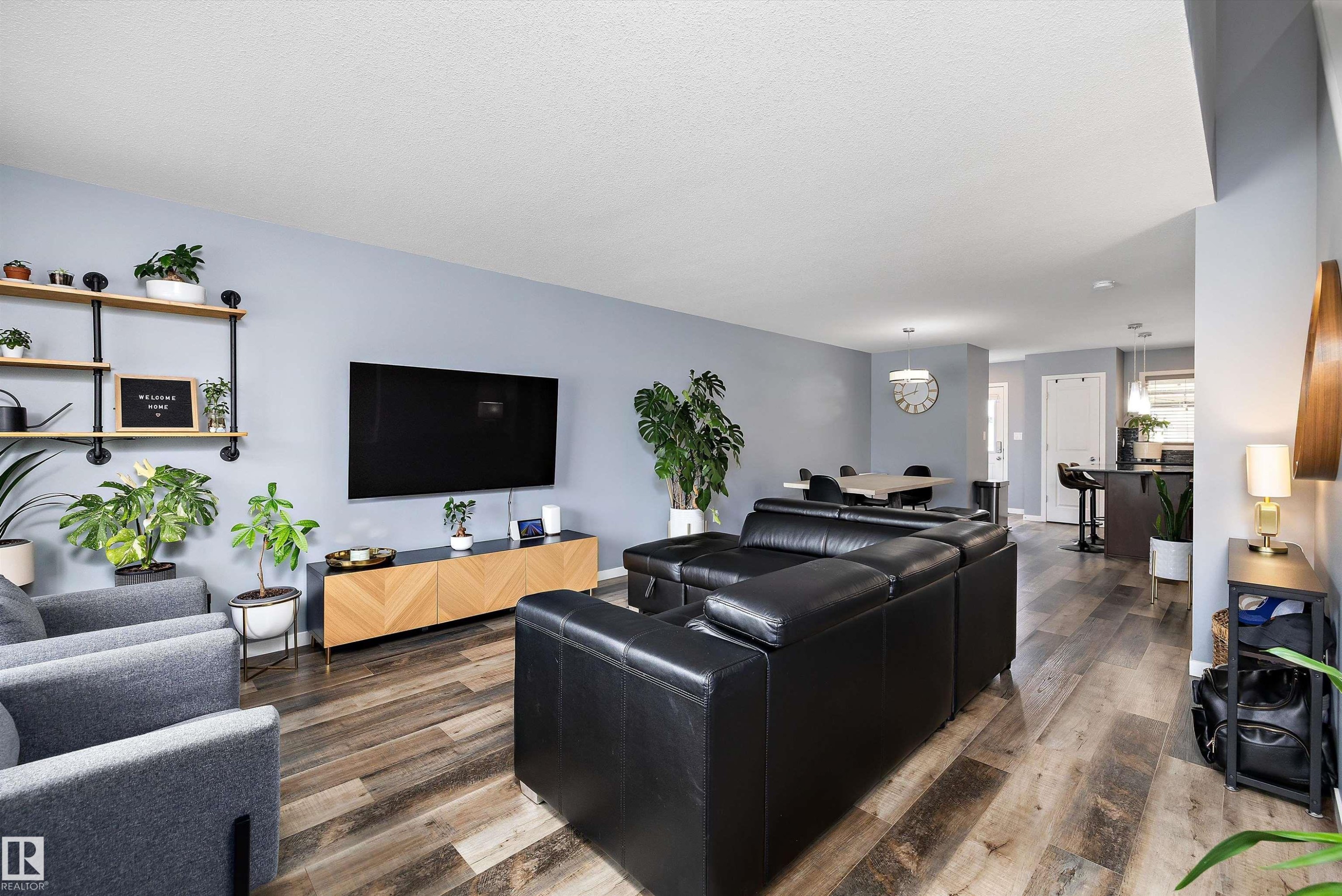 Open-concept living space featuring wood-finish flooring - 2833 Chokecherry Place, Edmonton, AB