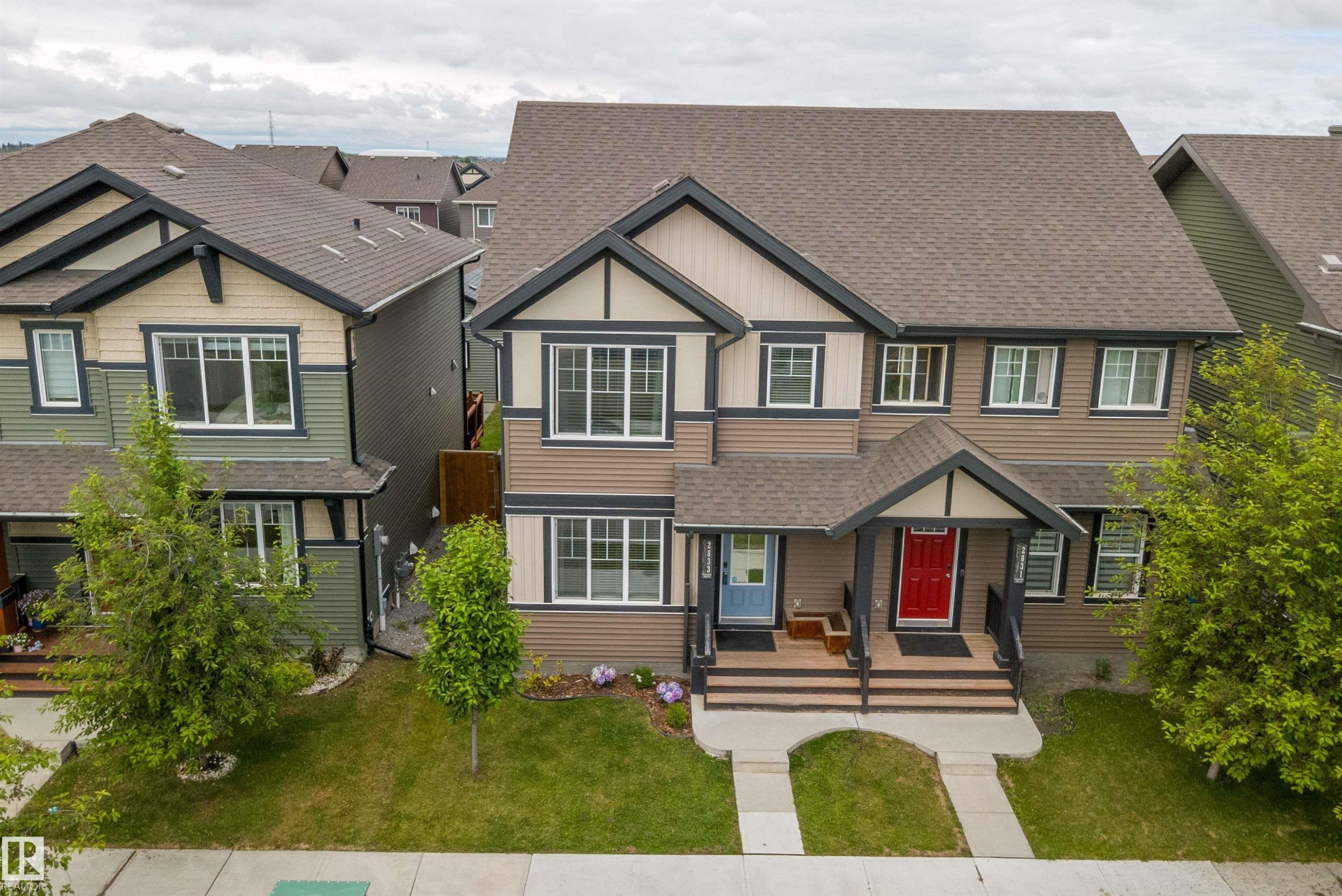 Two-story residential architecture with multiple gables and a combination of siding materials - 2833 Chokecherry Place, Edmonton, AB