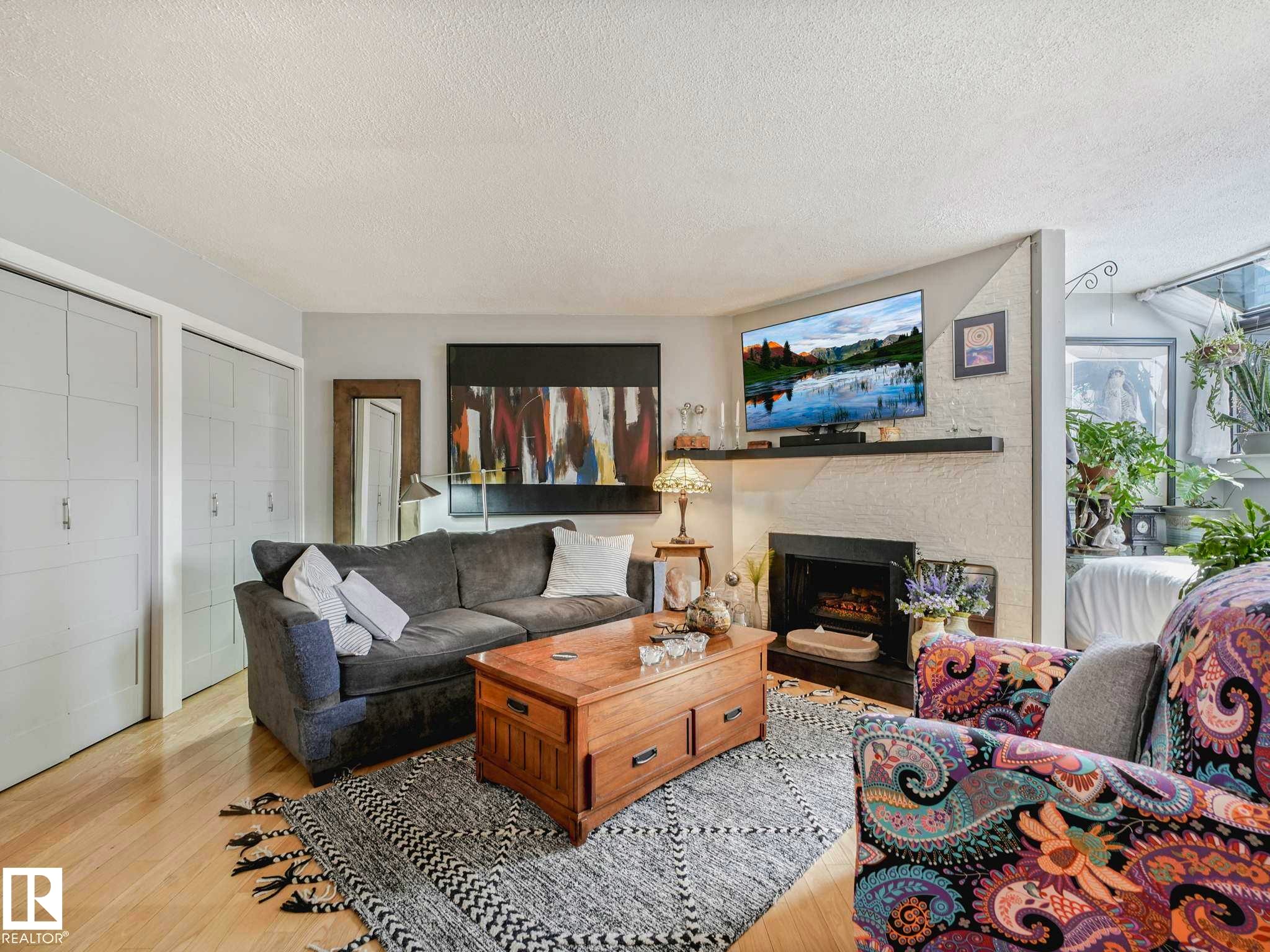 #201 10148 118 St Nw, Edmonton, AB - Indoor Photo Showing Living Room With Fireplace