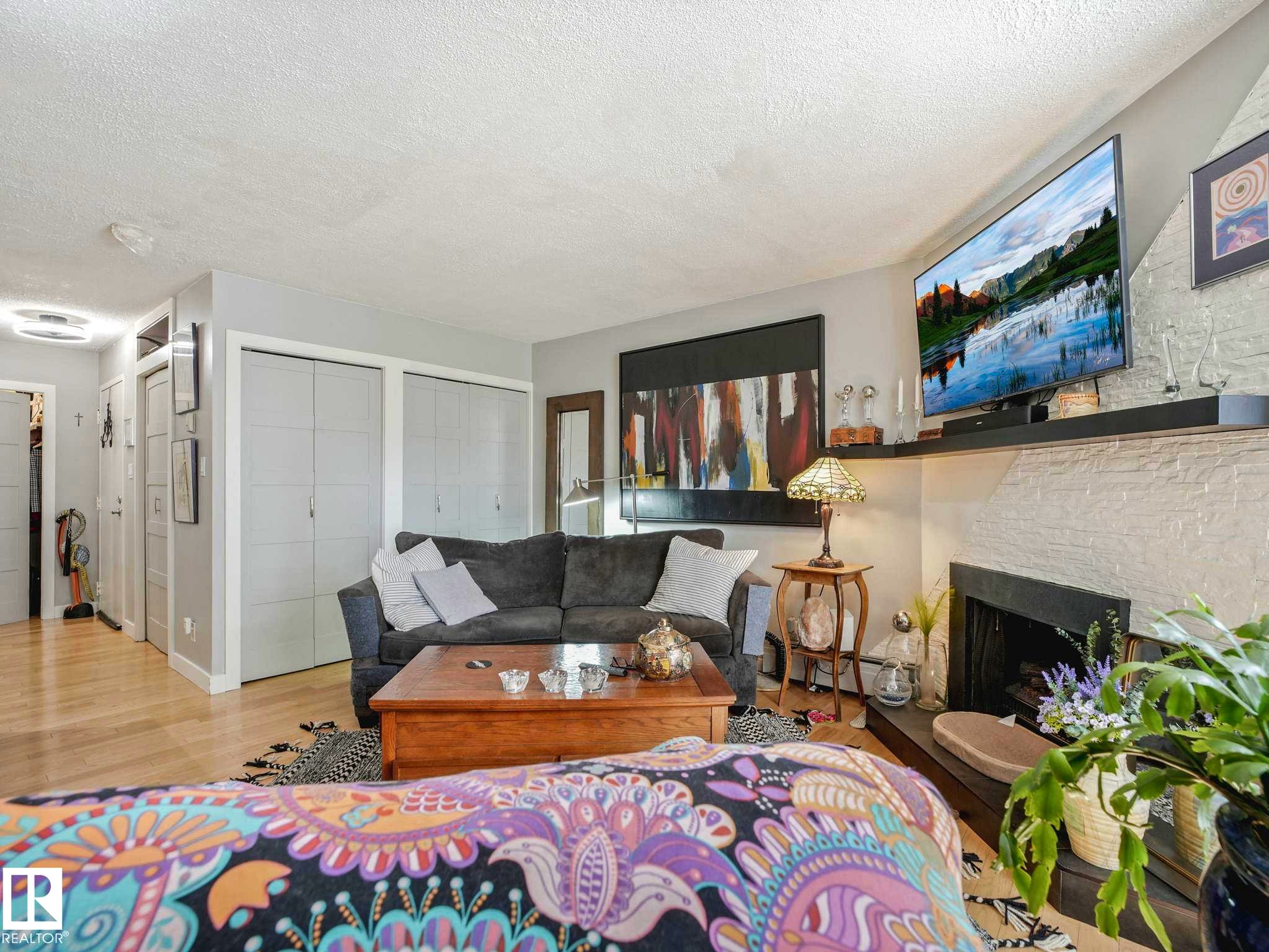 #201 10148 118 St Nw, Edmonton, AB - Indoor Photo Showing Living Room With Fireplace