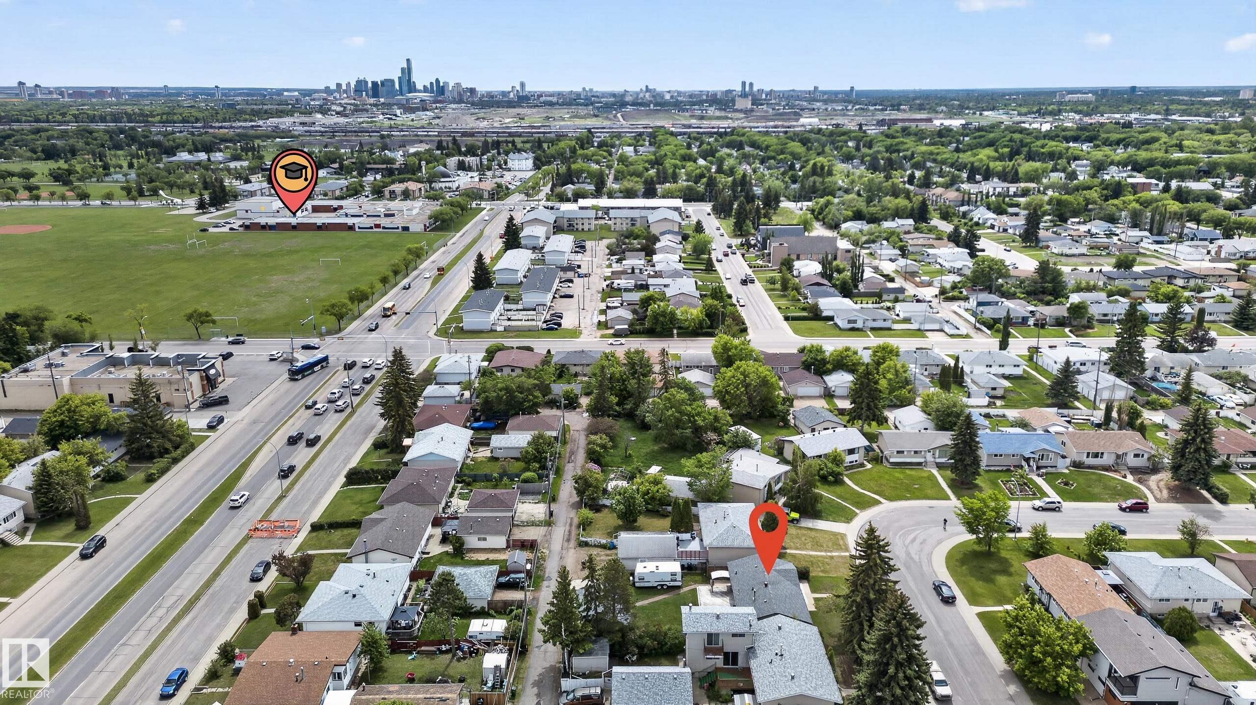 Aerial perspective showcasing a residential neighborhood with a distant cityscape - 13427 114 Street Nw, Edmonton, AB