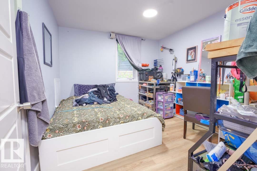 Room featuring wood-finish flooring, a single window with blinds, and recessed ceiling lighting - 11308 94 Street, Edmonton, AB