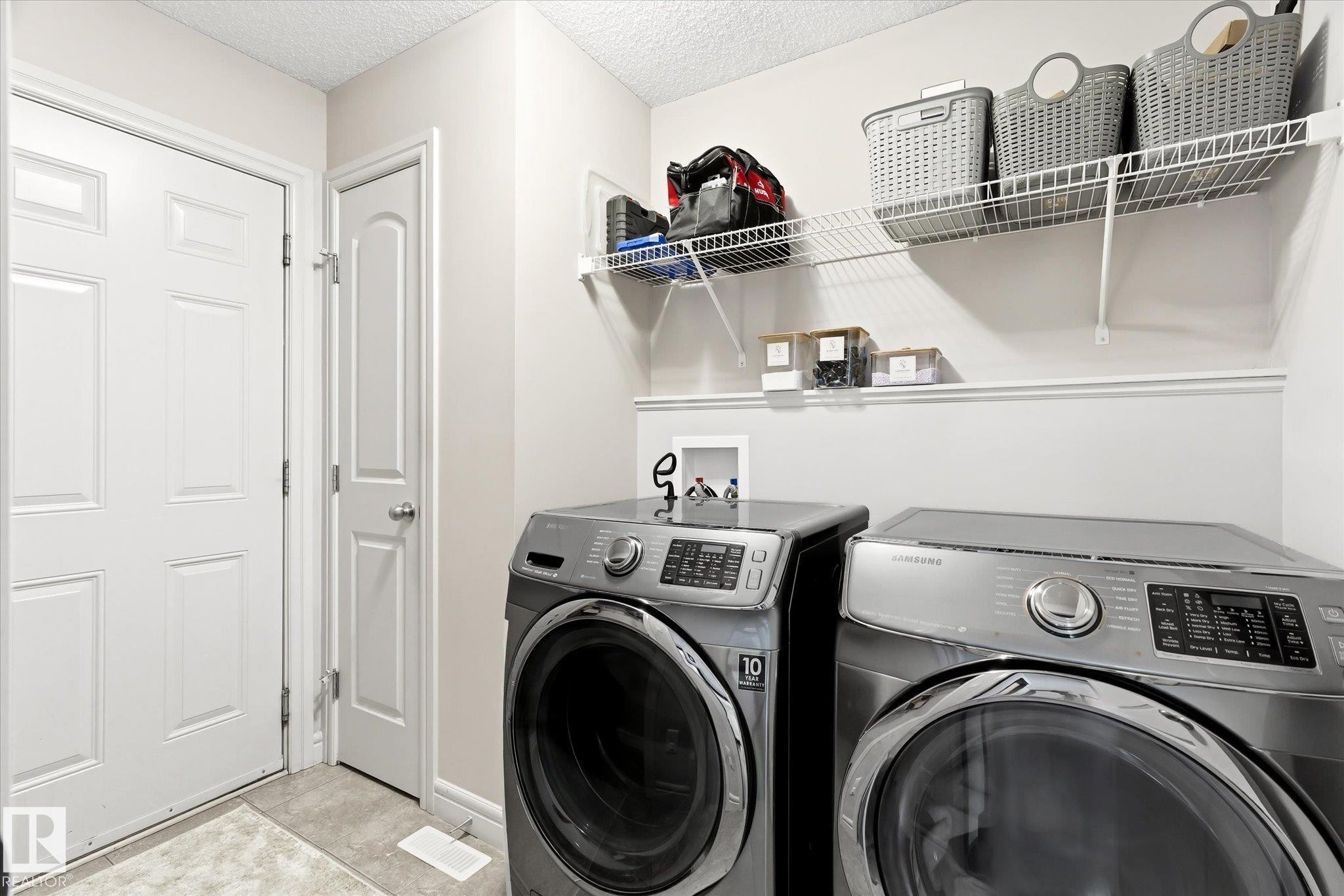 Utility space featuring light gray walls, white trim, and a textured ceiling - 3685 Westcliff Way, Edmonton, AB