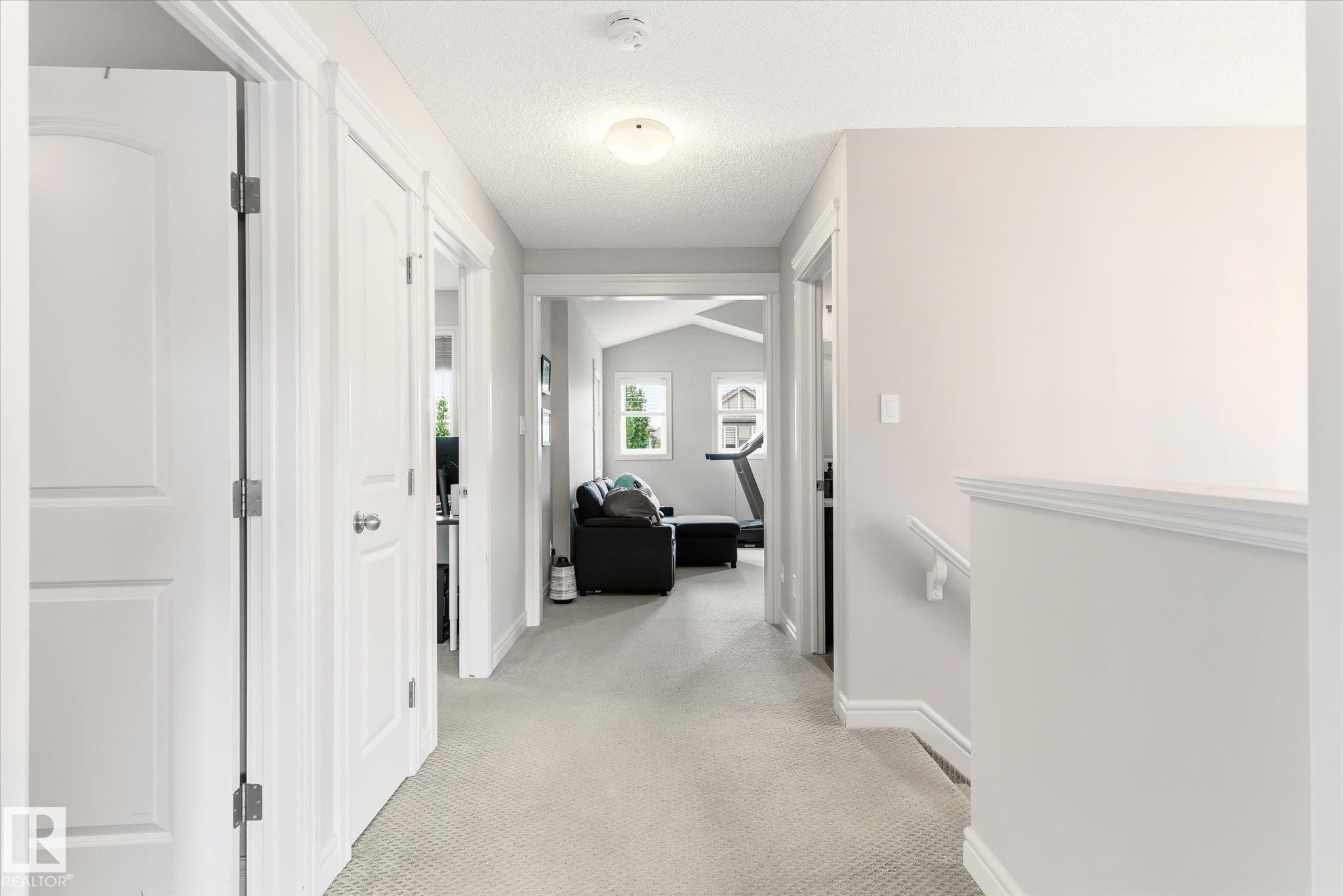Hallway featuring light gray carpeting, white trim, and white paneled doors - 3685 Westcliff Way, Edmonton, AB