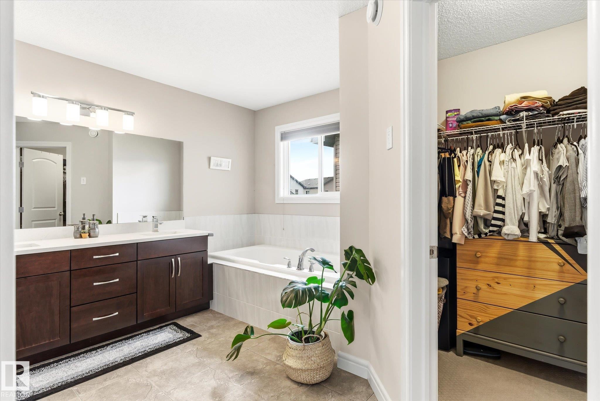 Spacious bathroom featuring a double vanity with dark wood cabinetry, white countertops, and dual sinks - 3685 Westcliff Way, Edmonton, AB