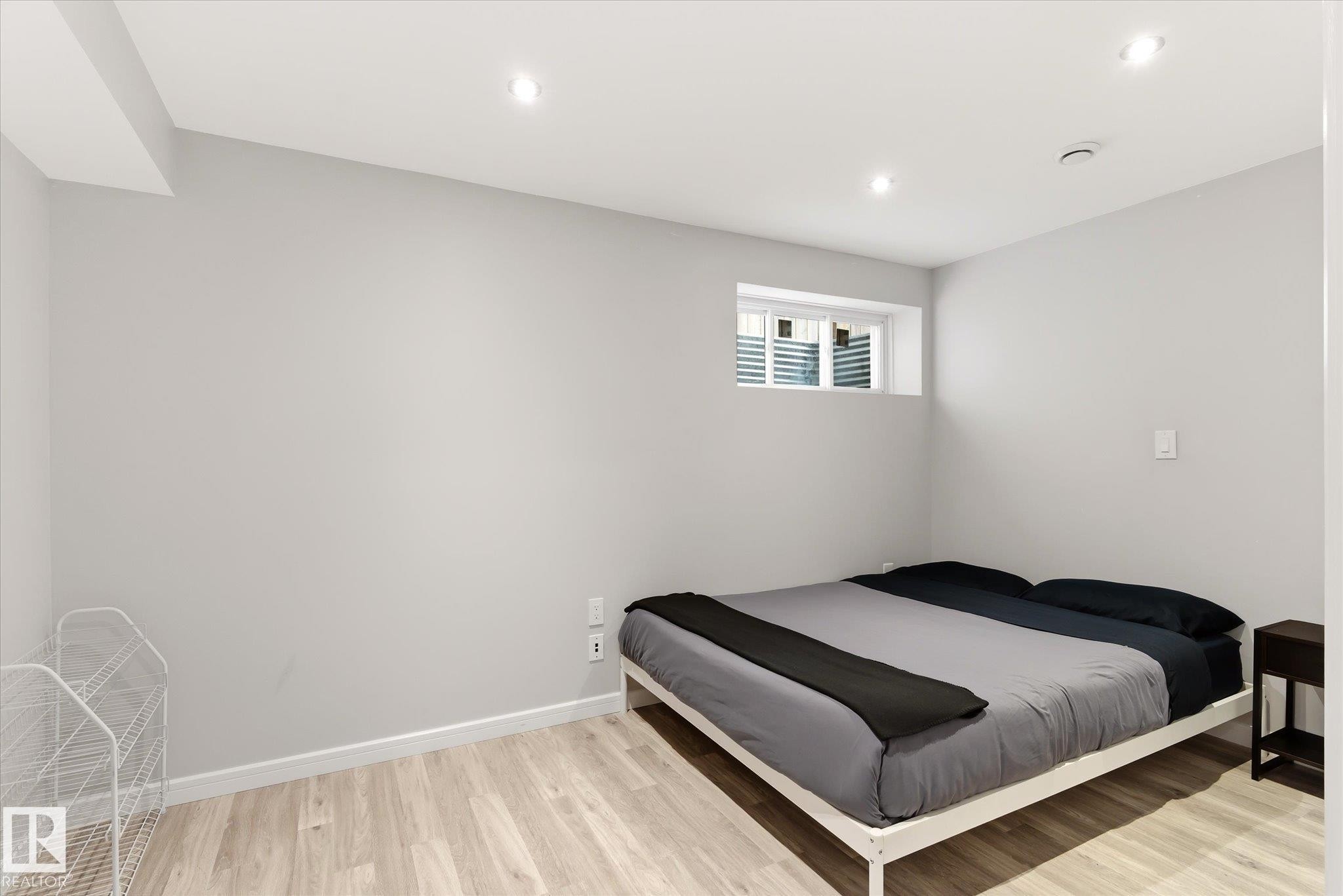 Recessed lighting illuminates this room, featuring light gray walls, white trim, and wood-finish flooring - 3685 Westcliff Way, Edmonton, AB
