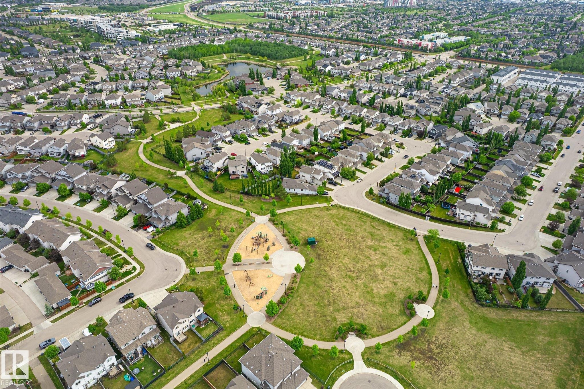 Aerial depiction of a residential community featuring extensive green spaces, a central park with playground structures, and a pond - 3685 Westcliff Way, Edmonton, AB