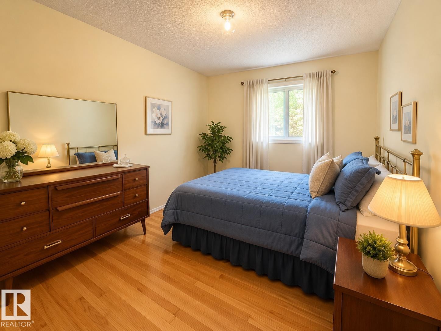 Hardwood flooring throughout featuring a window with natural light, neutral wall colors, and a ceiling-mounted light fixture - 1 Munro Court, Leduc, AB