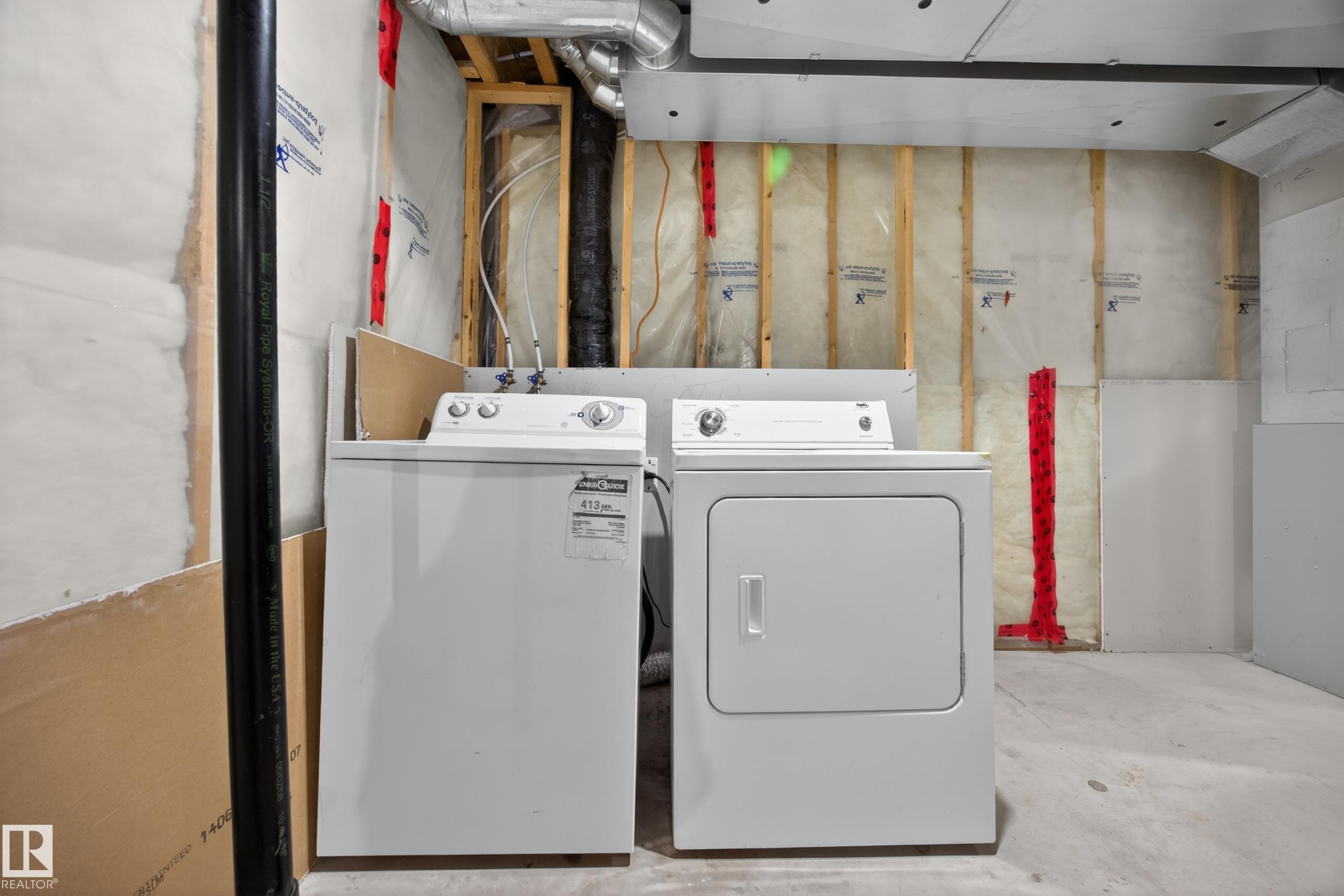 Laundry area featuring a white top-load washing machine and a white electric dryer - 3634 12 Street, Edmonton, AB