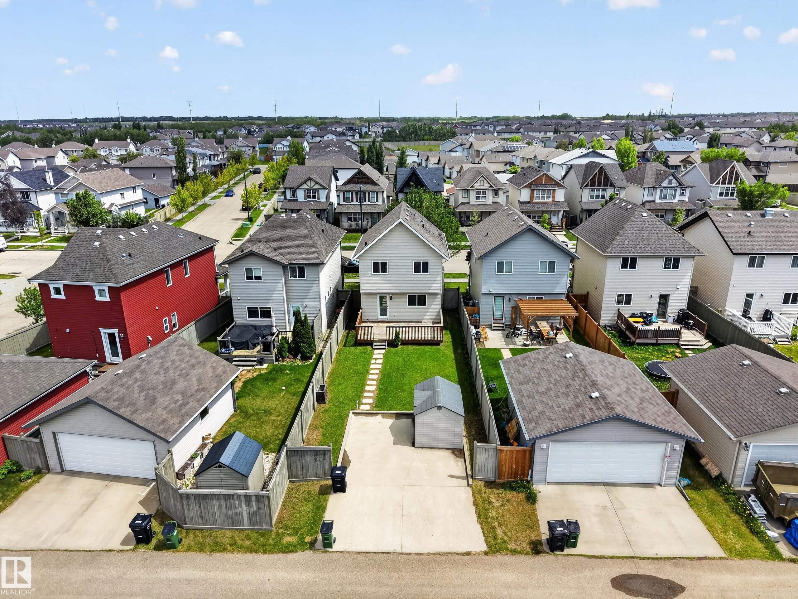 Two-story residence with light-colored siding and a rear deck - 3634 12 Street, Edmonton, AB