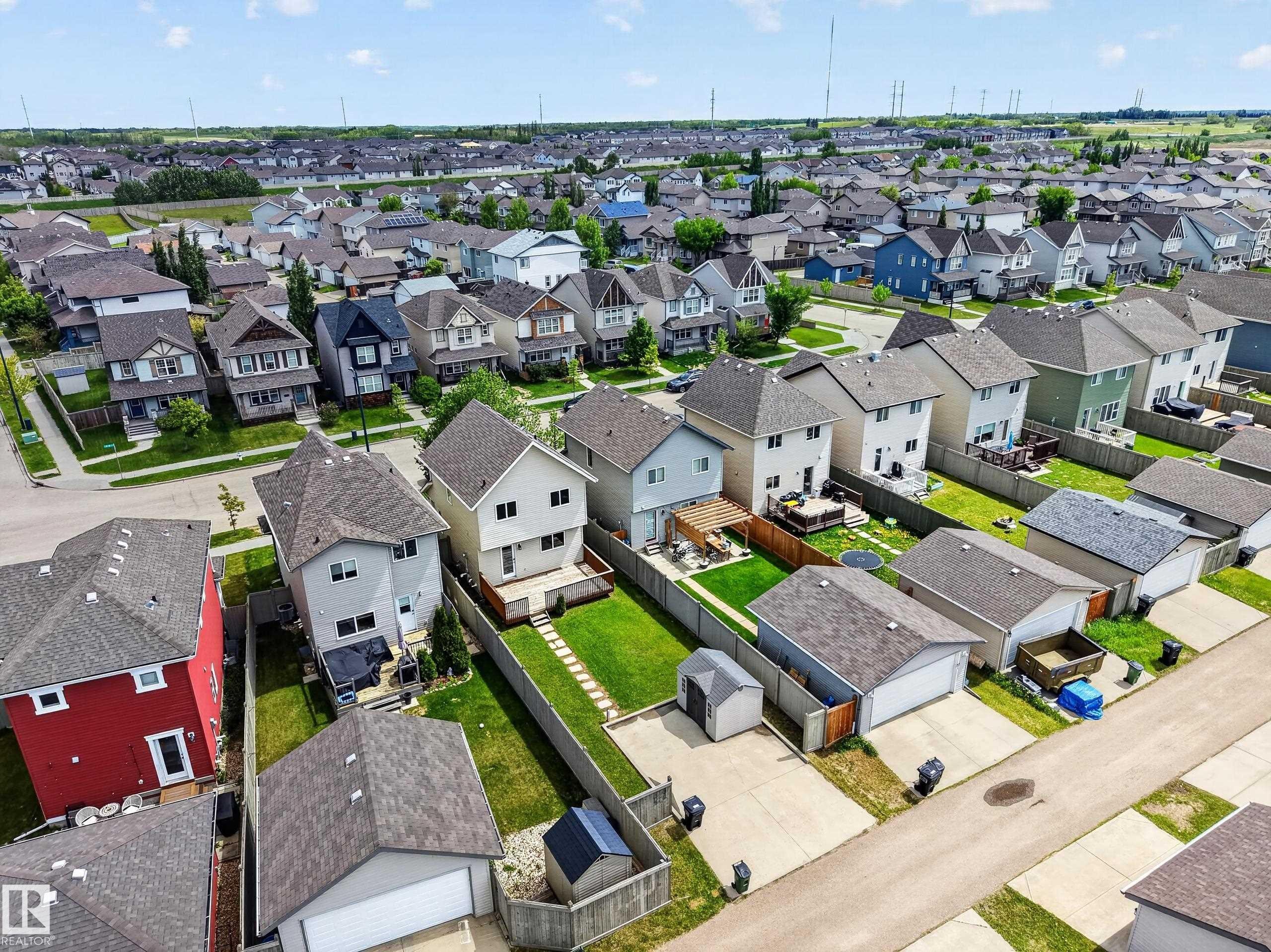 Aerial perspective showcasing a residential neighborhood with diverse housing styles - 3634 12 Street, Edmonton, AB