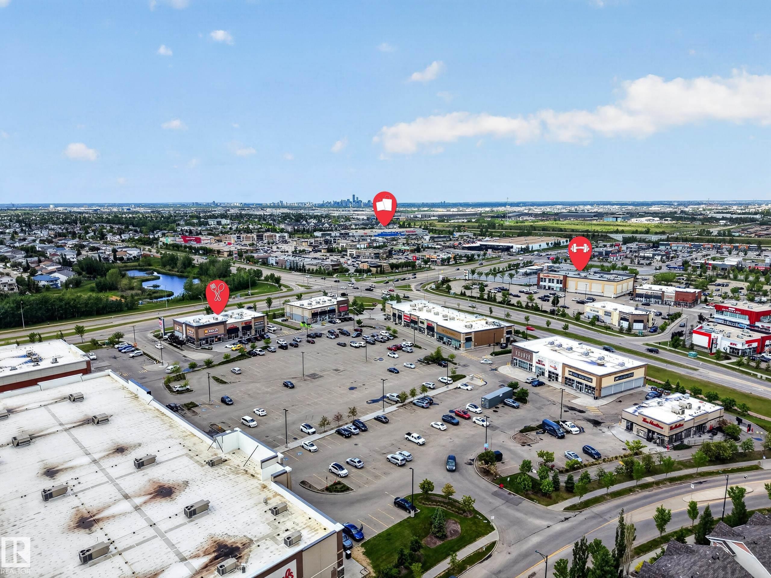 Commercial development featuring multiple buildings, expansive asphalt parking lots, and surrounding roadways - 3634 12 Street, Edmonton, AB