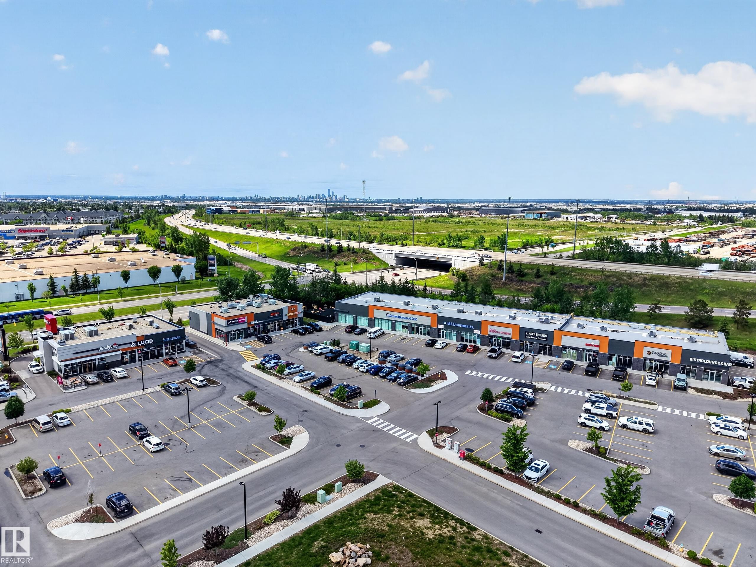 Retail plaza with multiple tenant spaces, ample surface parking, and direct highway access - 3634 12 Street, Edmonton, AB