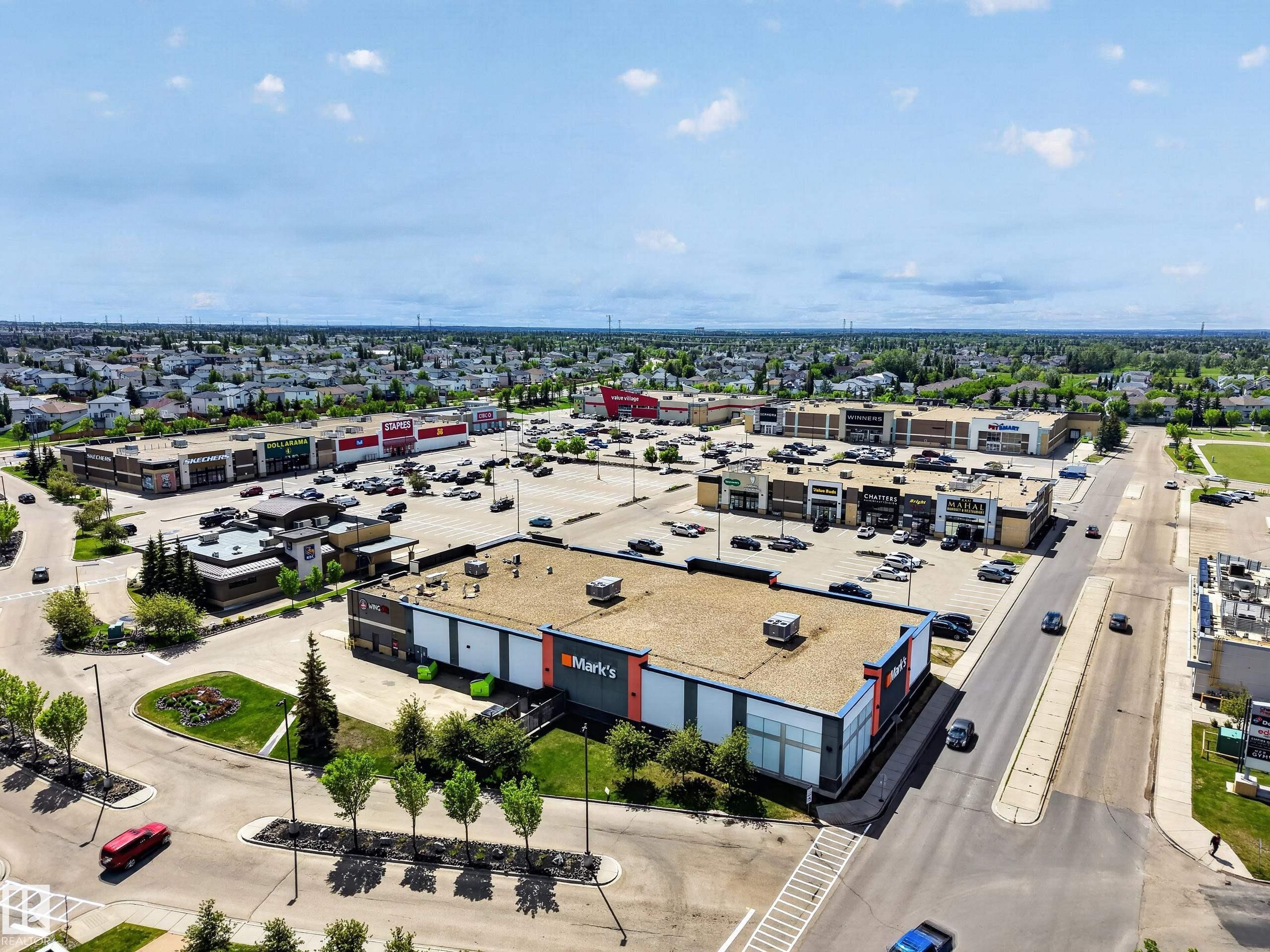 Extensive commercial complex featuring multiple retail storefronts, ample surface parking, and direct road access - 3634 12 Street, Edmonton, AB