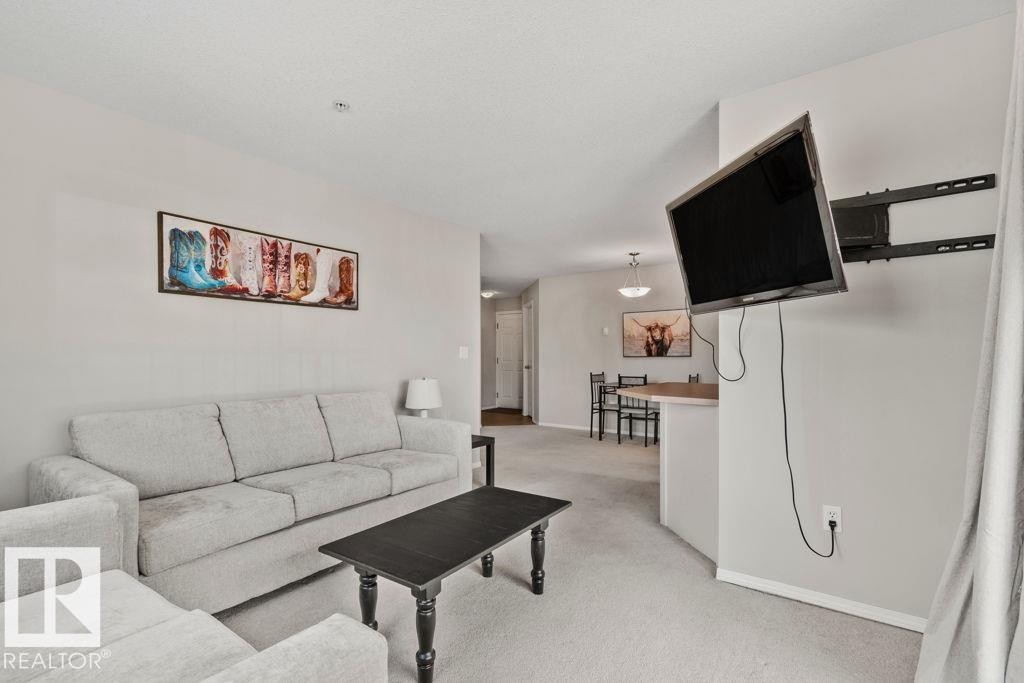Expansive living area featuring light-colored carpeting and neutral wall tones - 232 4309 33 Street, Stony Plain, AB