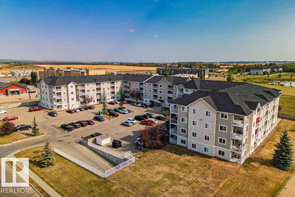 Multi-story residential buildings featuring light gray siding and white trim - 232 4309 33 Street, Stony Plain, AB