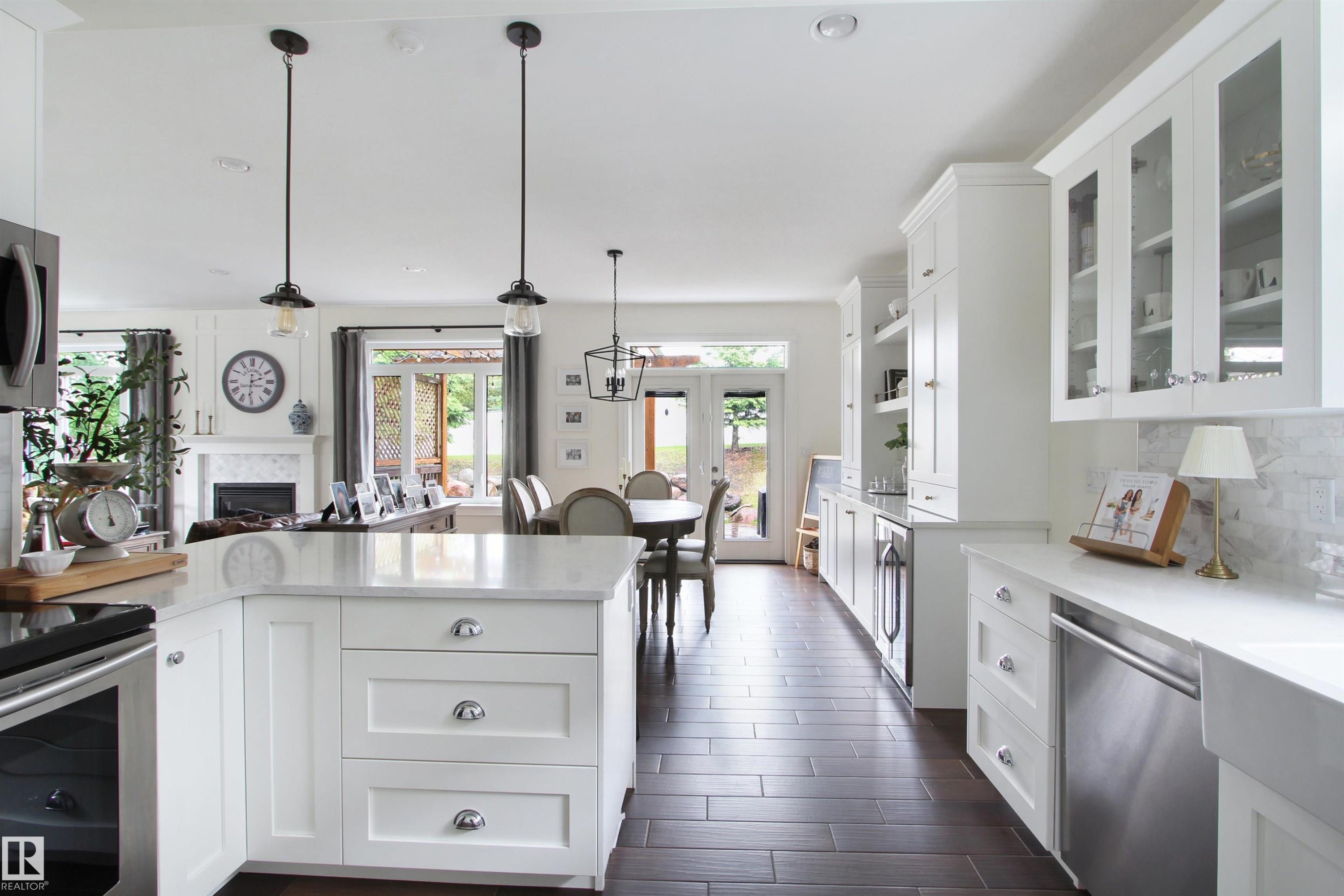 Open-concept kitchen and dining area with dark wood-finish flooring - 34 Falcon Road, Cold Lake, AB