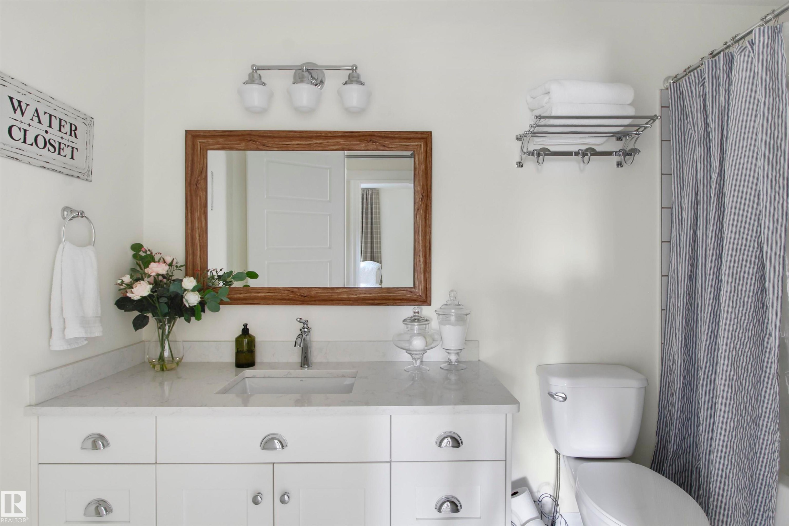 White vanity with integrated sink and chrome faucet - 34 Falcon Road, Cold Lake, AB