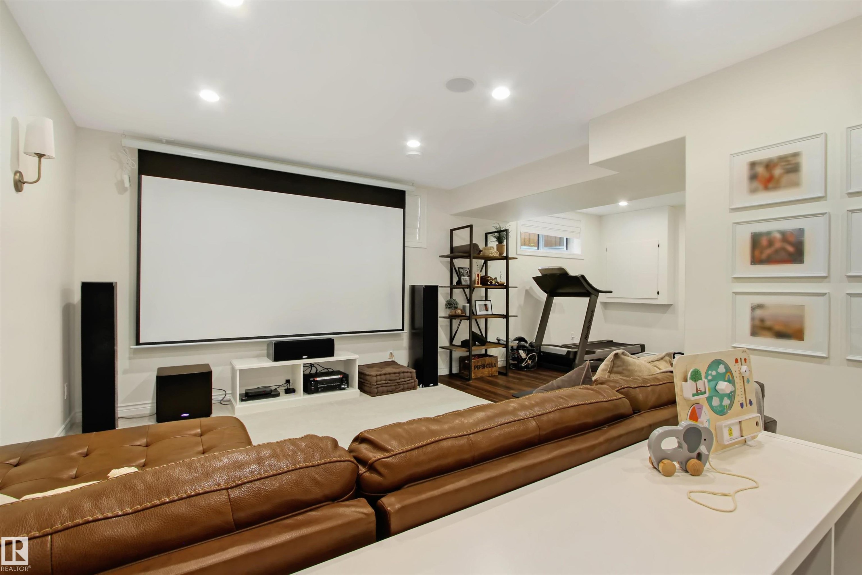 Recreational space featuring a large projection screen, recessed lighting, and wall-mounted sconces - 34 Falcon Road, Cold Lake, AB