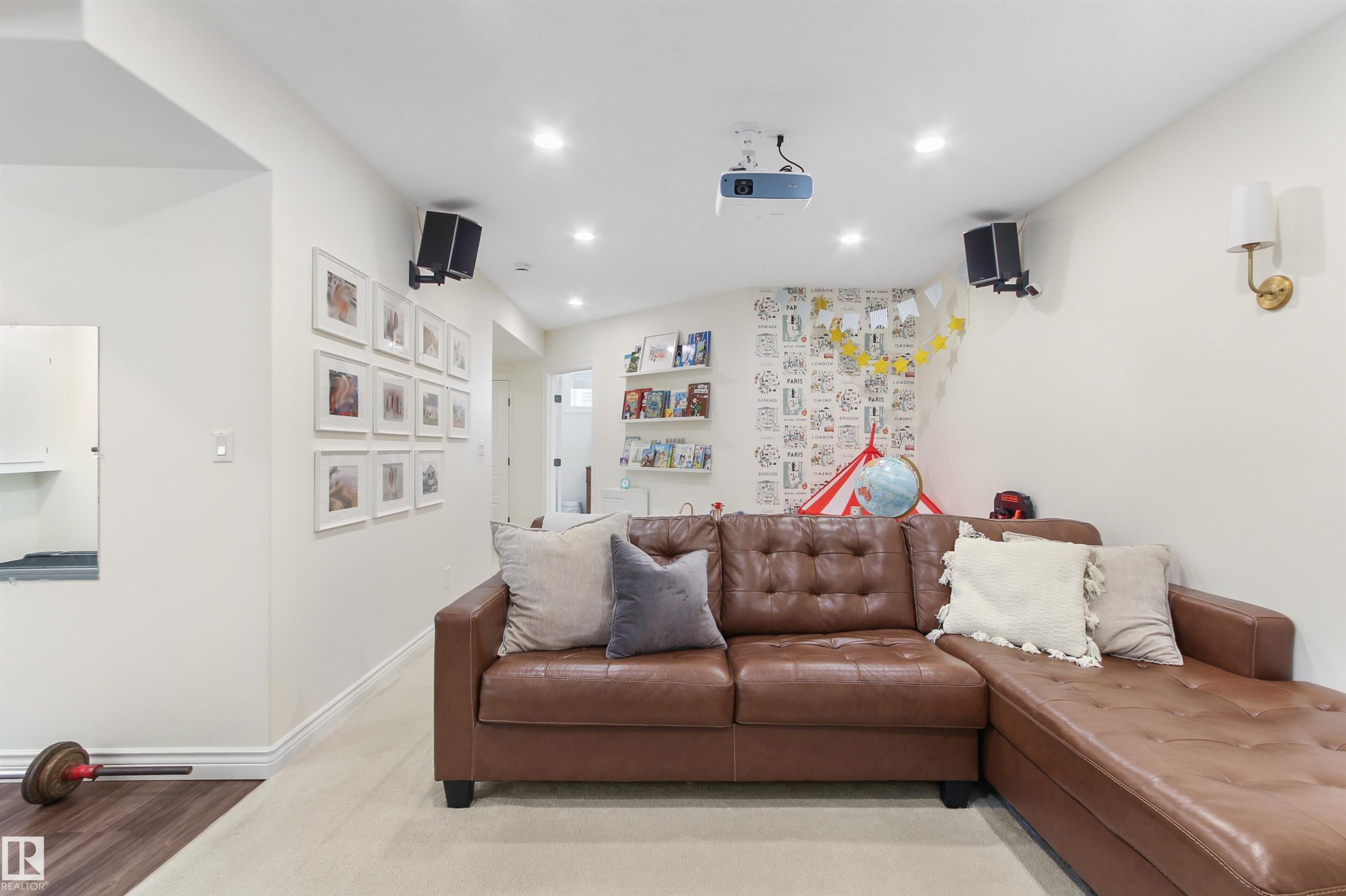 Recreation room featuring recessed lighting, a ceiling-mounted projector, wall-mounted speakers, and a wall sconce - 34 Falcon Road, Cold Lake, AB