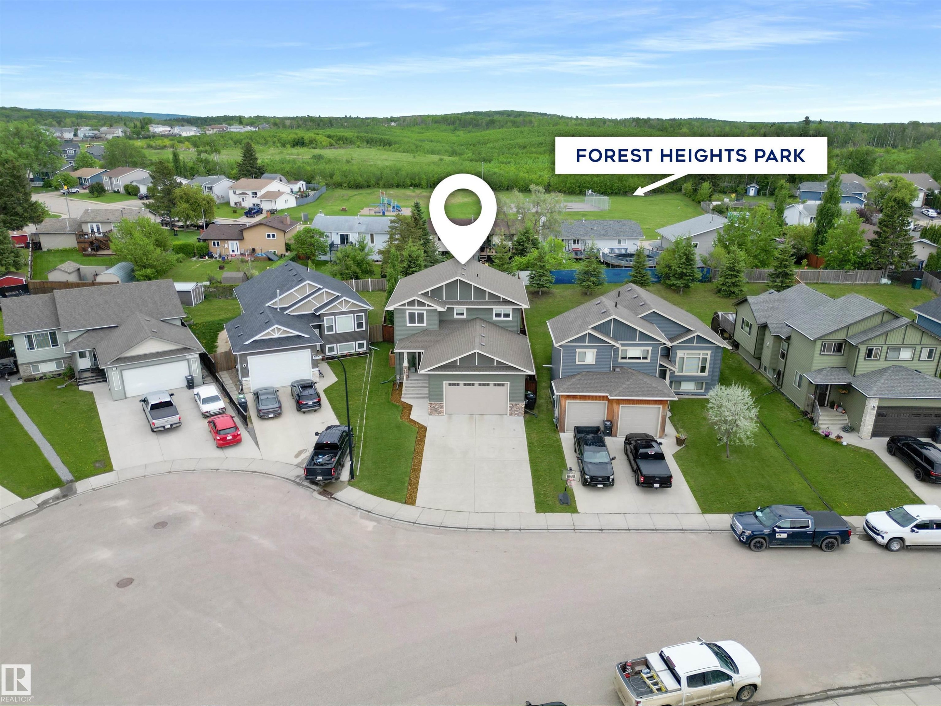 Modern two-story residence with a gray exterior and white trim accents - 34 Falcon Road, Cold Lake, AB