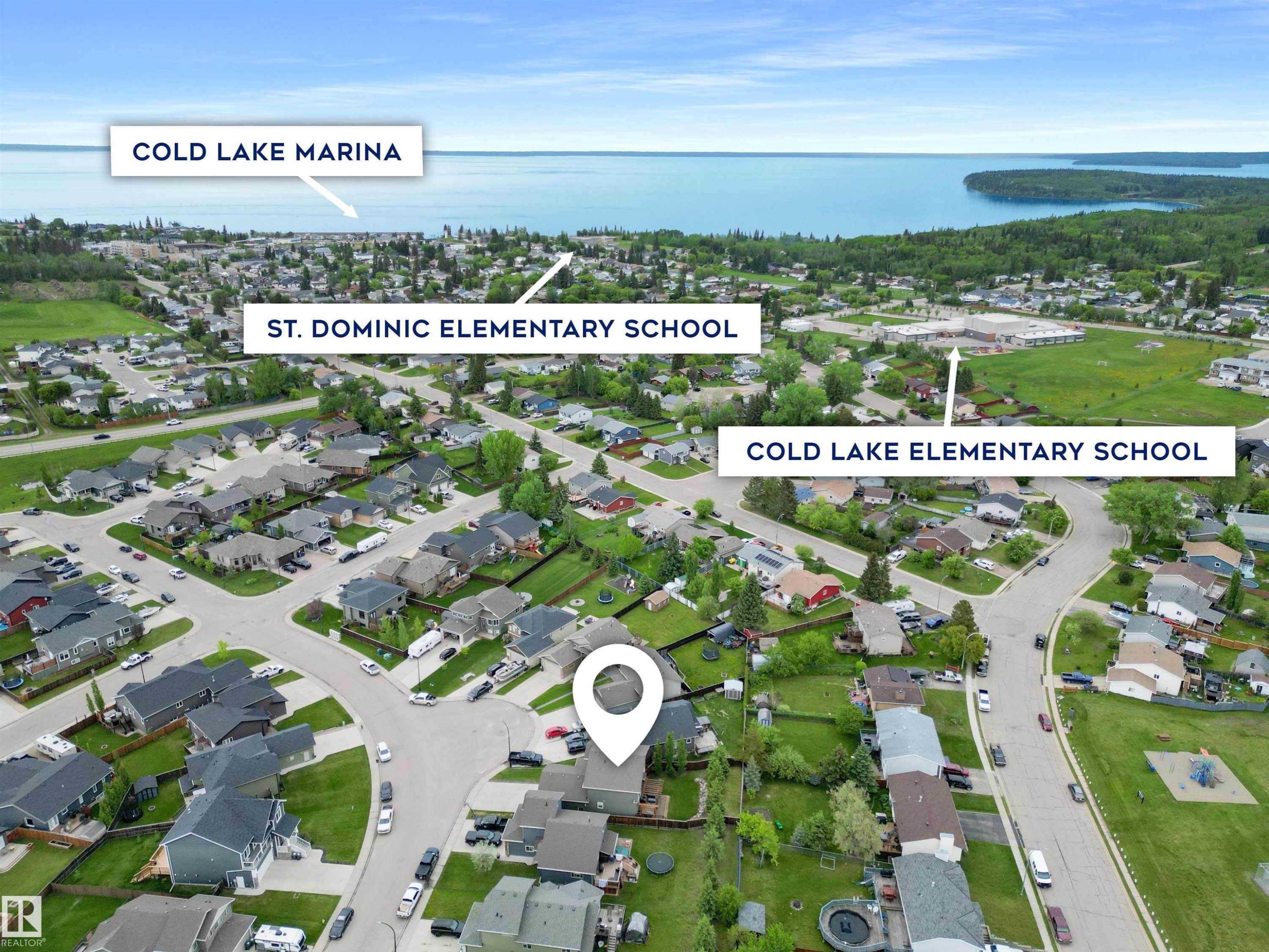 Aerial perspective of a residential neighborhood with established streets and mature trees - 34 Falcon Road, Cold Lake, AB