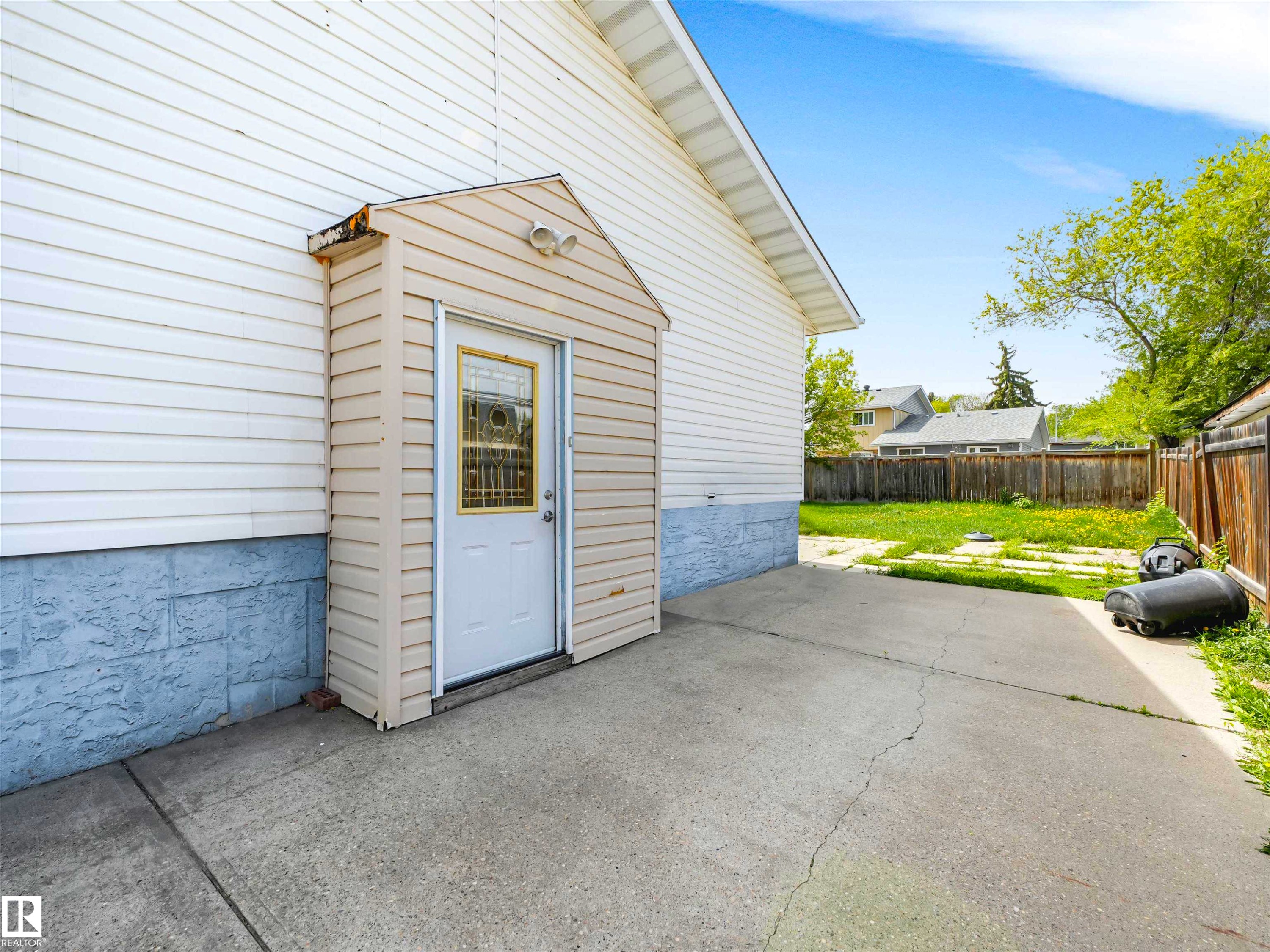 Exterior access door with window pane detailing, set within a siding enclosure - 13114 30 Street, Edmonton, AB - Outdoor With Exterior