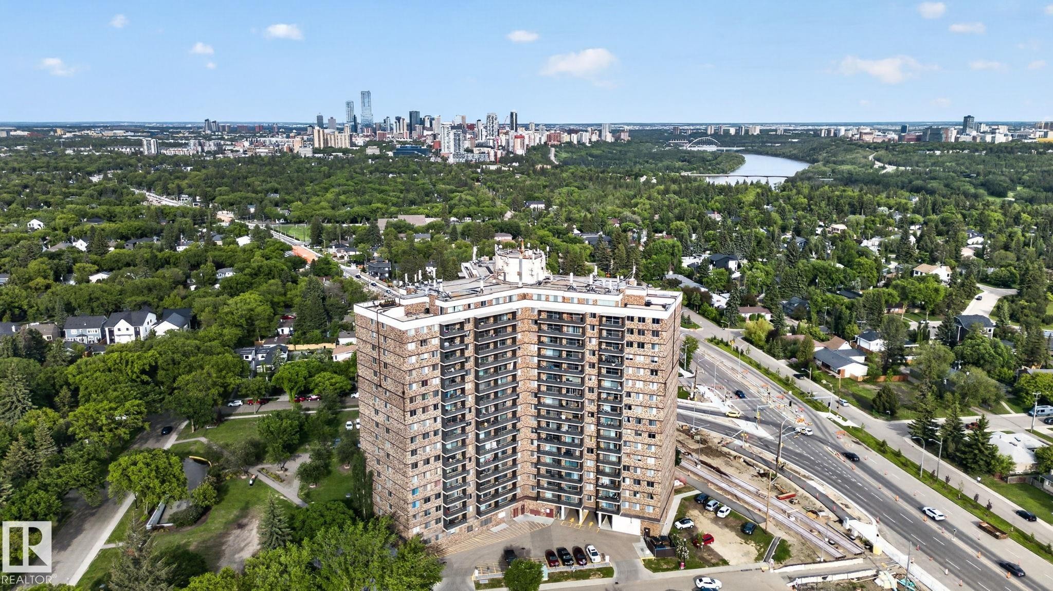 High-rise residential building featuring multiple levels of private balconies, a flat roofline, and an integrated parking area - #412 13910 Stony Plain Rd Nw, Edmonton, AB - Outdoor With View