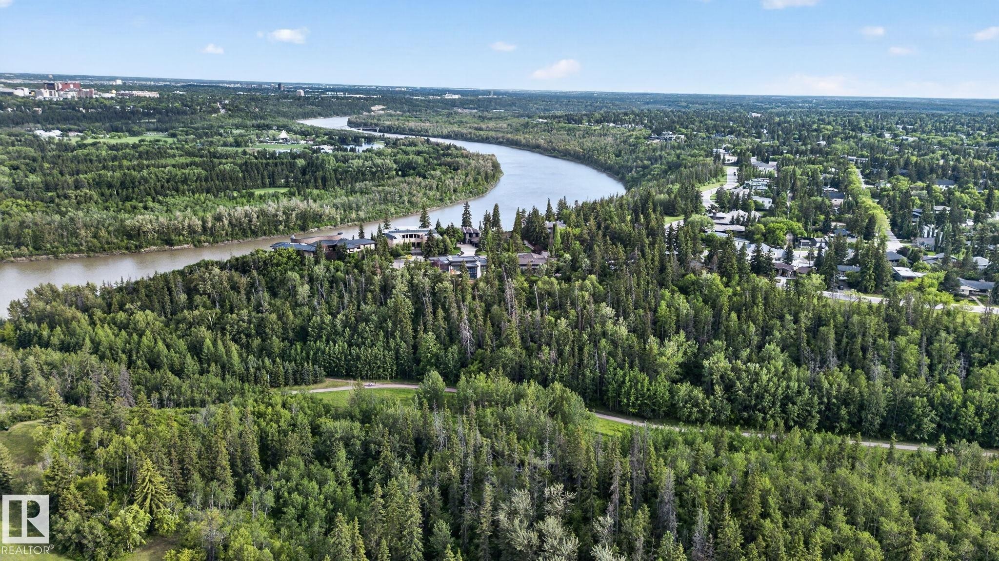 Riverfront properties nestled within a dense tree line, bordering a winding river - #412 13910 Stony Plain Rd Nw, Edmonton, AB - Outdoor With View