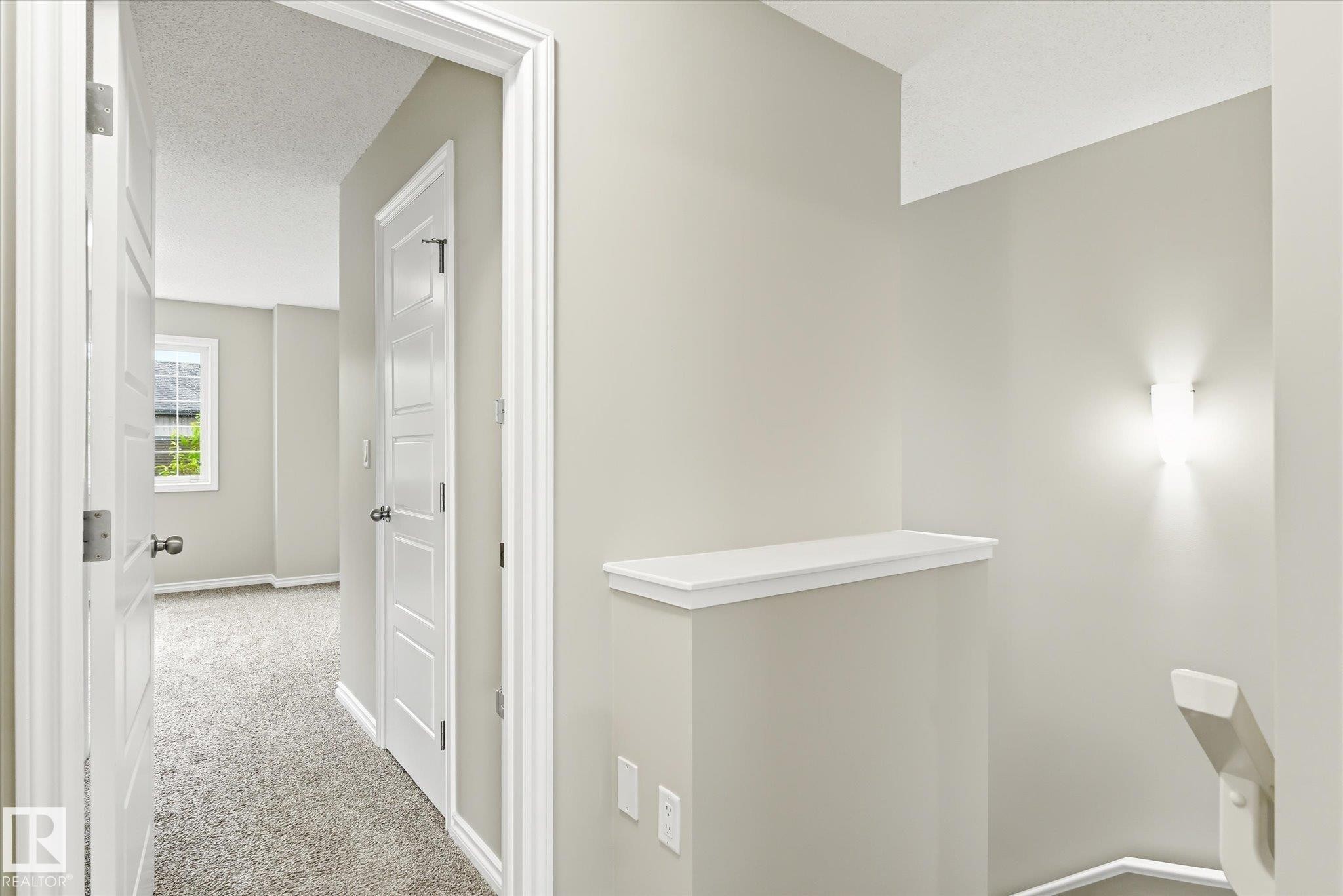 Neutral-toned interior hall with carpeted flooring - 9039 219 Street, Edmonton, AB