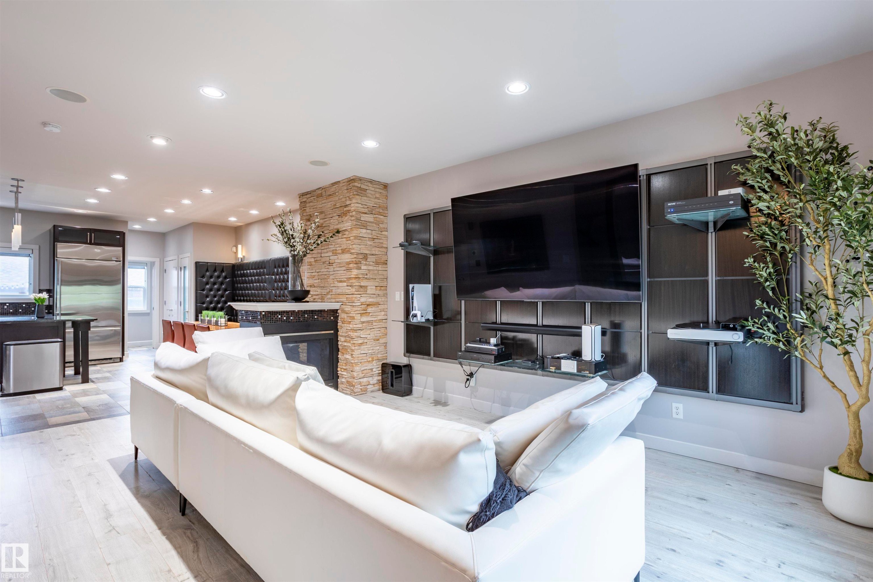 Living area with light wood-finish flooring and recessed lighting - 4949 Terwillegar Common Nw, Edmonton, AB