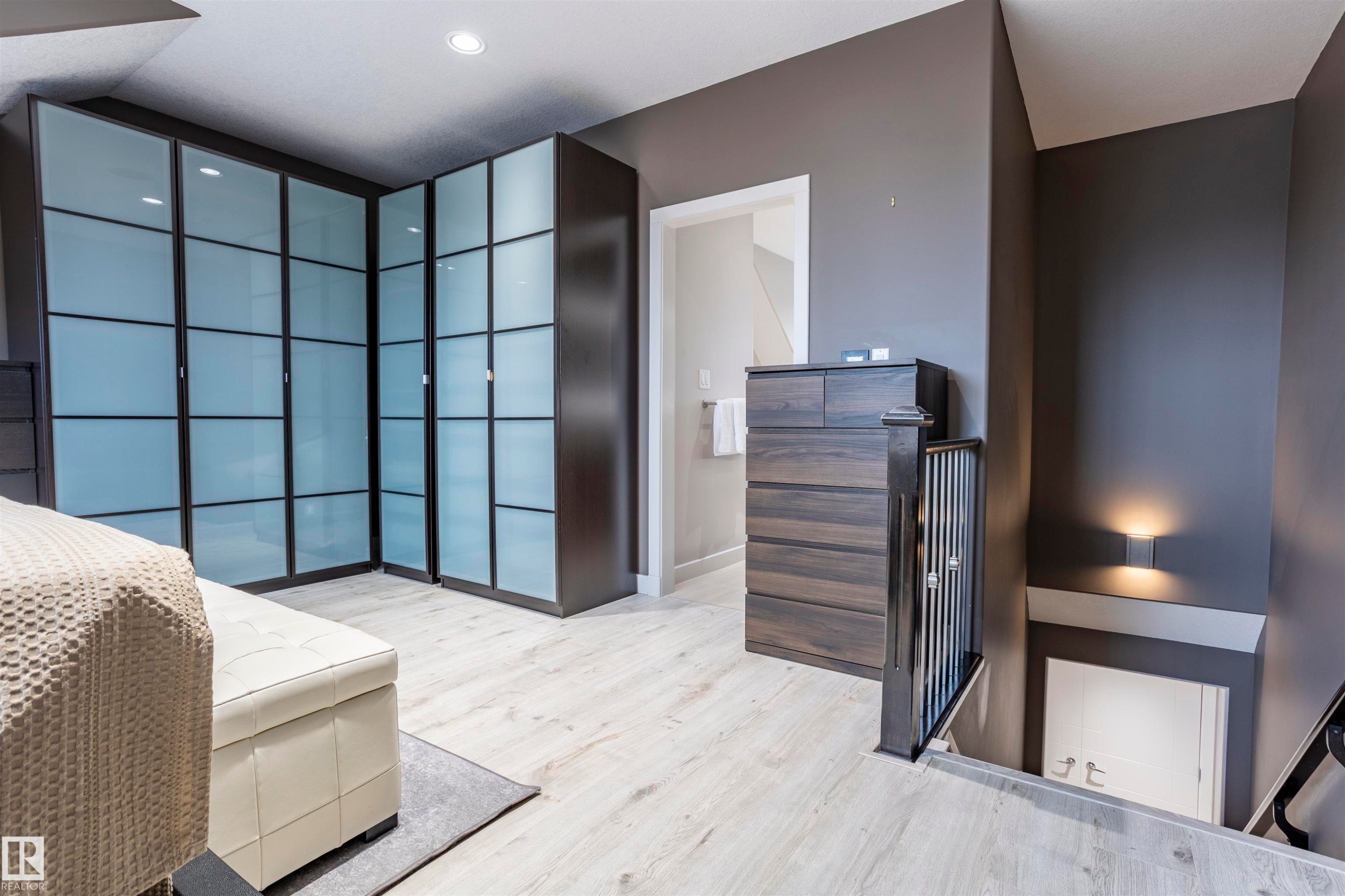 Corner wardrobe system with frosted glass panels and dark frames - 4949 Terwillegar Common Nw, Edmonton, AB