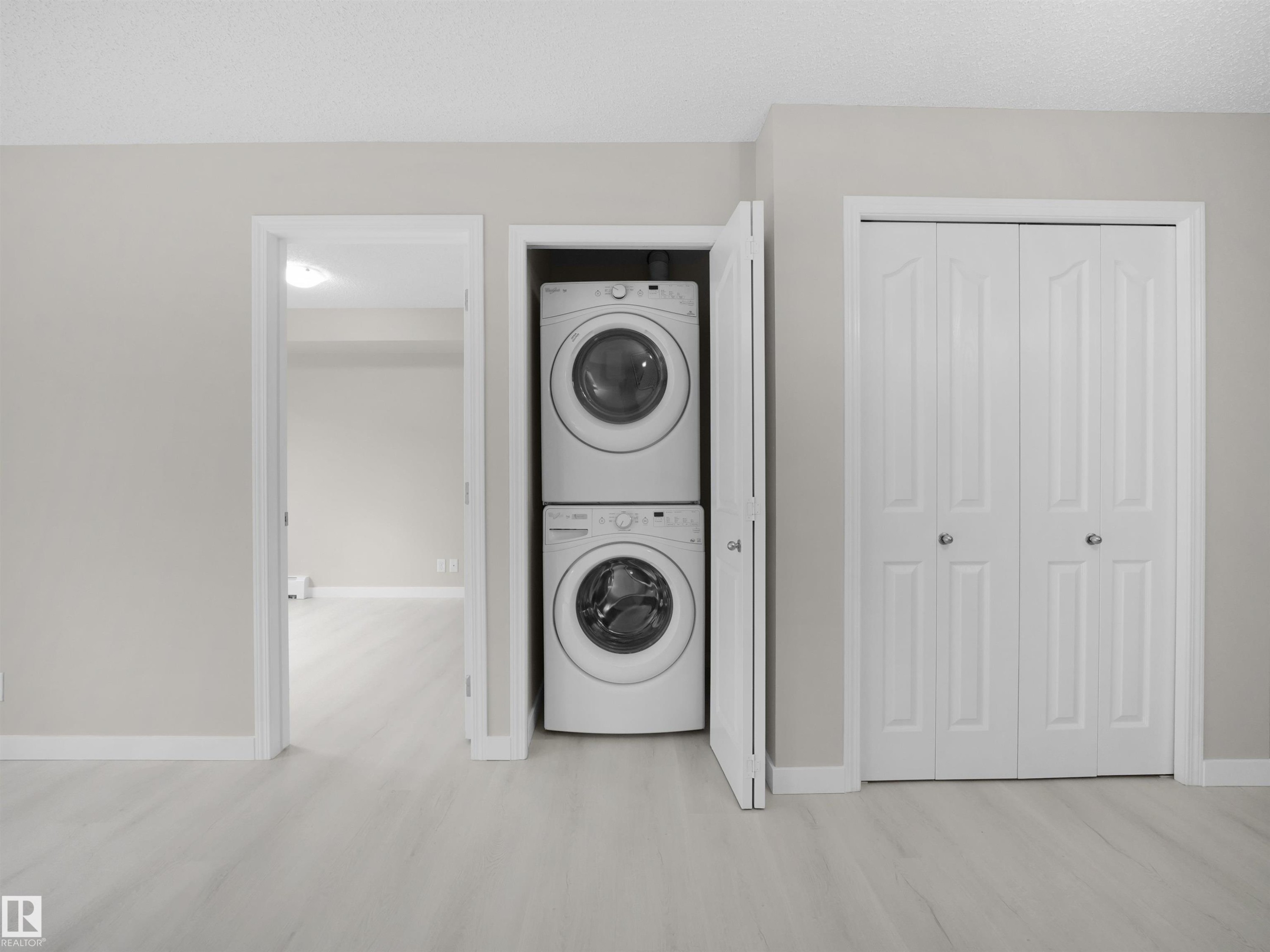 Stacked washer and dryer unit within a dedicated closet - 220 12035 22 Avenue, Edmonton, AB