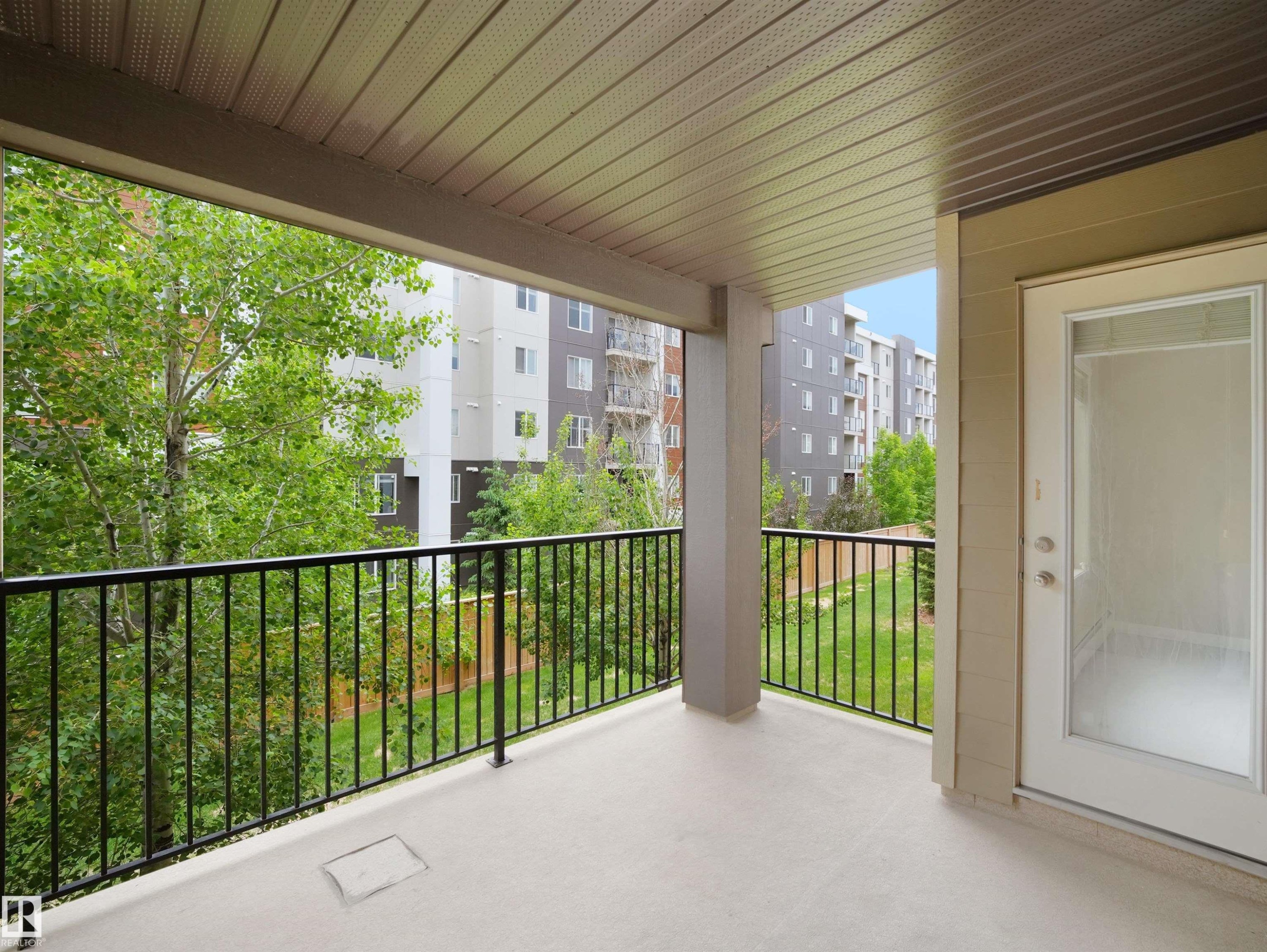 Private balcony featuring a concrete surface and black metal railing - 220 12035 22 Avenue, Edmonton, AB