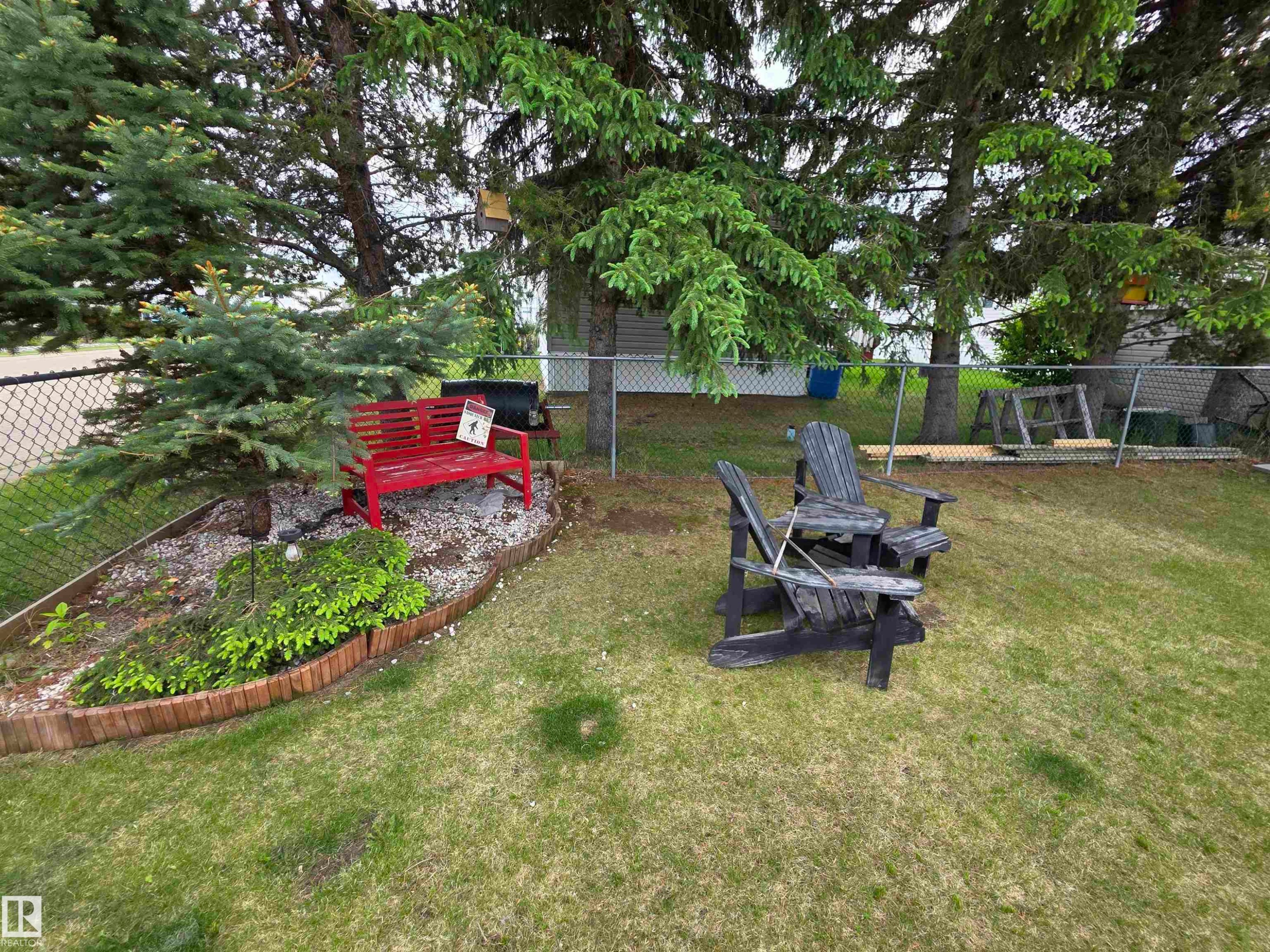 Green lawn with mature trees and a chain-link fence - 88B 3400 48 Street, Stony Plain, AB
