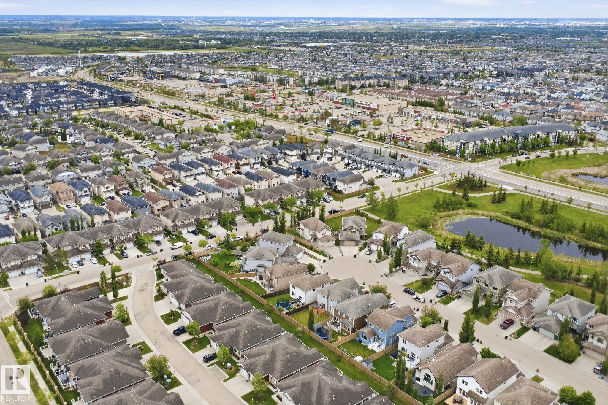 Aerial perspective showcasing a residential community with varied architectural styles - 115 274 Mcconachie Drive, Edmonton, AB