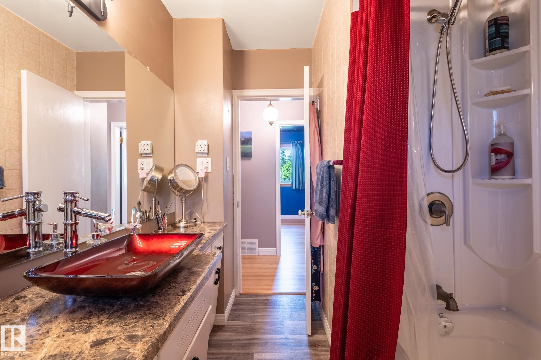 Vanity featuring a vessel sink, a stone-finish countertop, and chrome fixtures - 14708 108 Av, Edmonton, AB