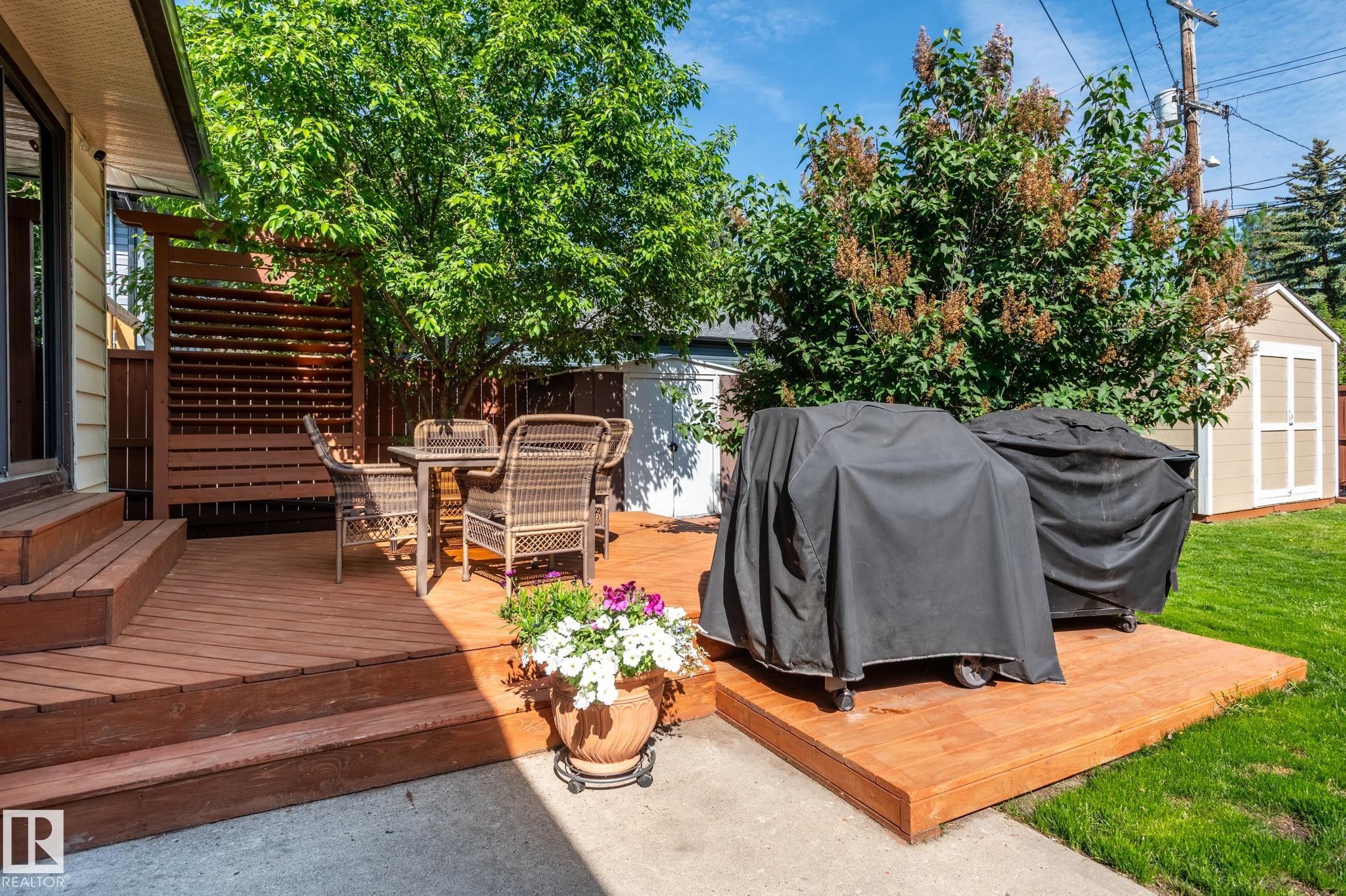 Expansive wood deck with multi-level design and slatted privacy screen - 14708 108 Av, Edmonton, AB