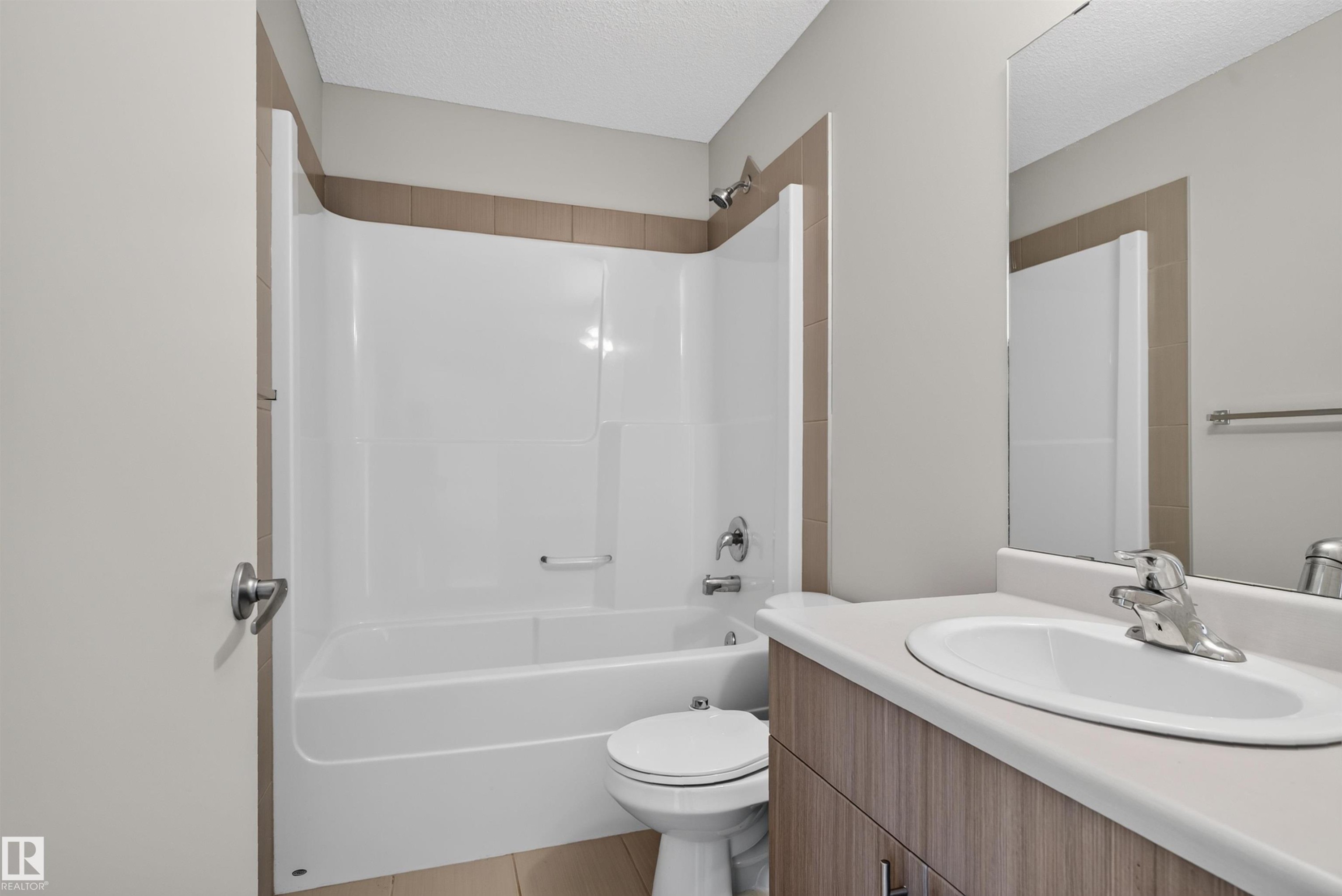 Bathroom featuring a single vanity with wood-finish cabinetry, a white countertop, and an integrated sink - 4612 Westcliff Point(E), Edmonton, AB