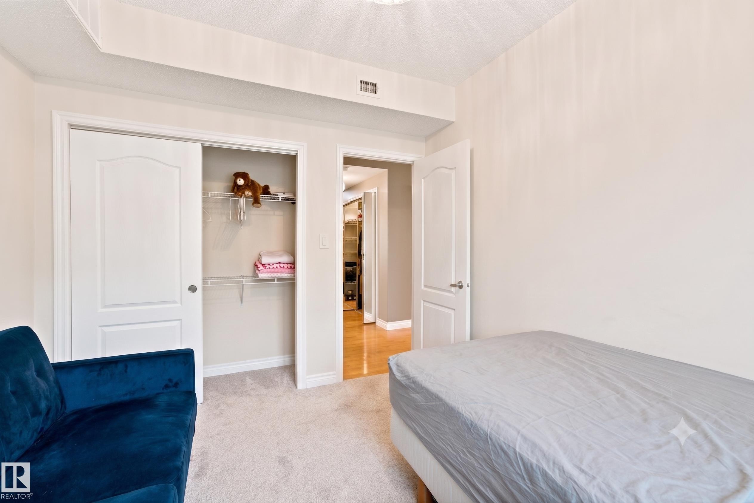 Carpeted interior space featuring a double-door closet with wire shelving - 305 11111 82 Avenue, Edmonton, AB