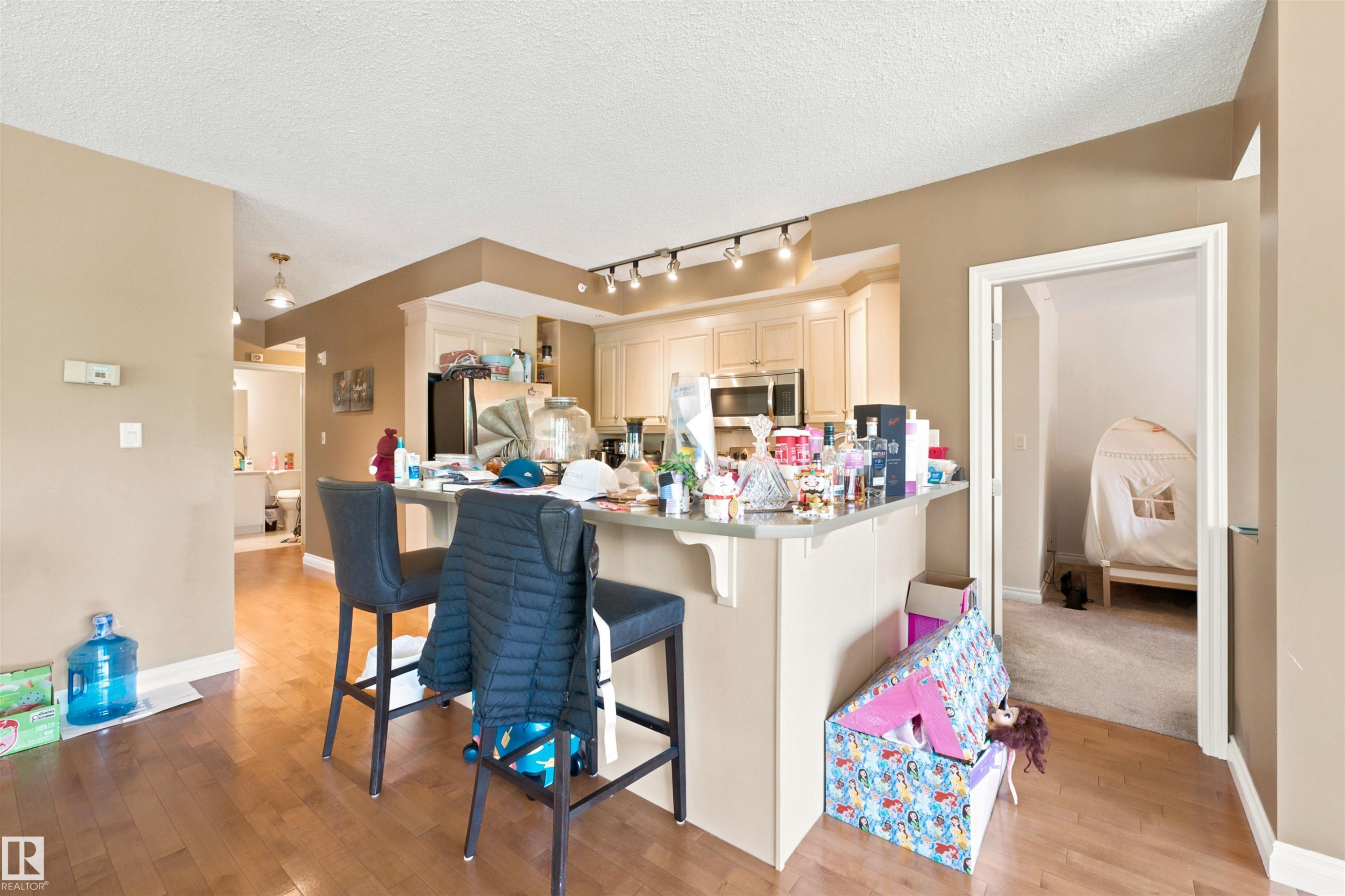 Kitchen featuring light-toned cabinetry and stainless steel appliances - 305 11111 82 Avenue, Edmonton, AB