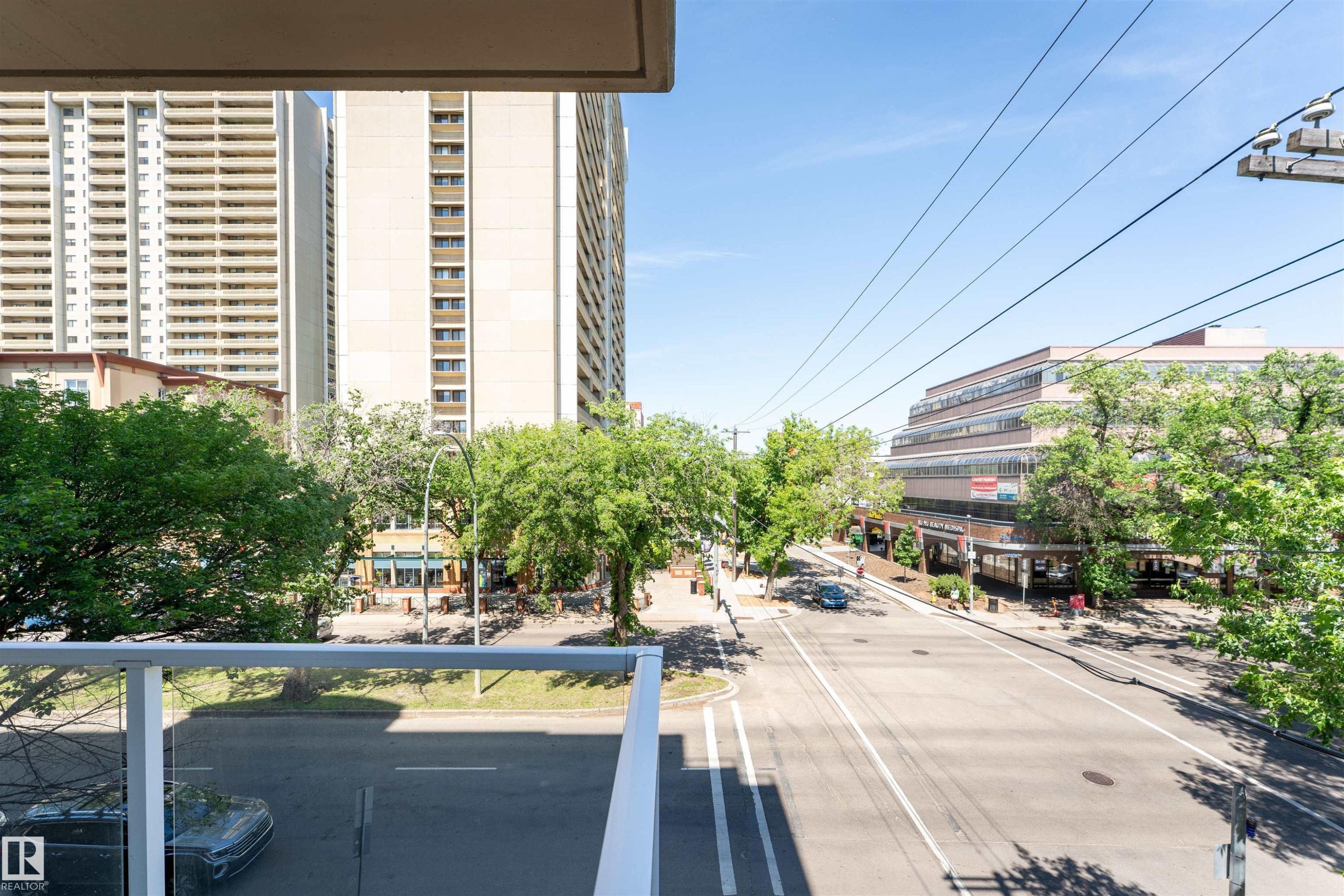 Balcony with glass railing overlooking urban streetscape - 305 11111 82 Avenue, Edmonton, AB