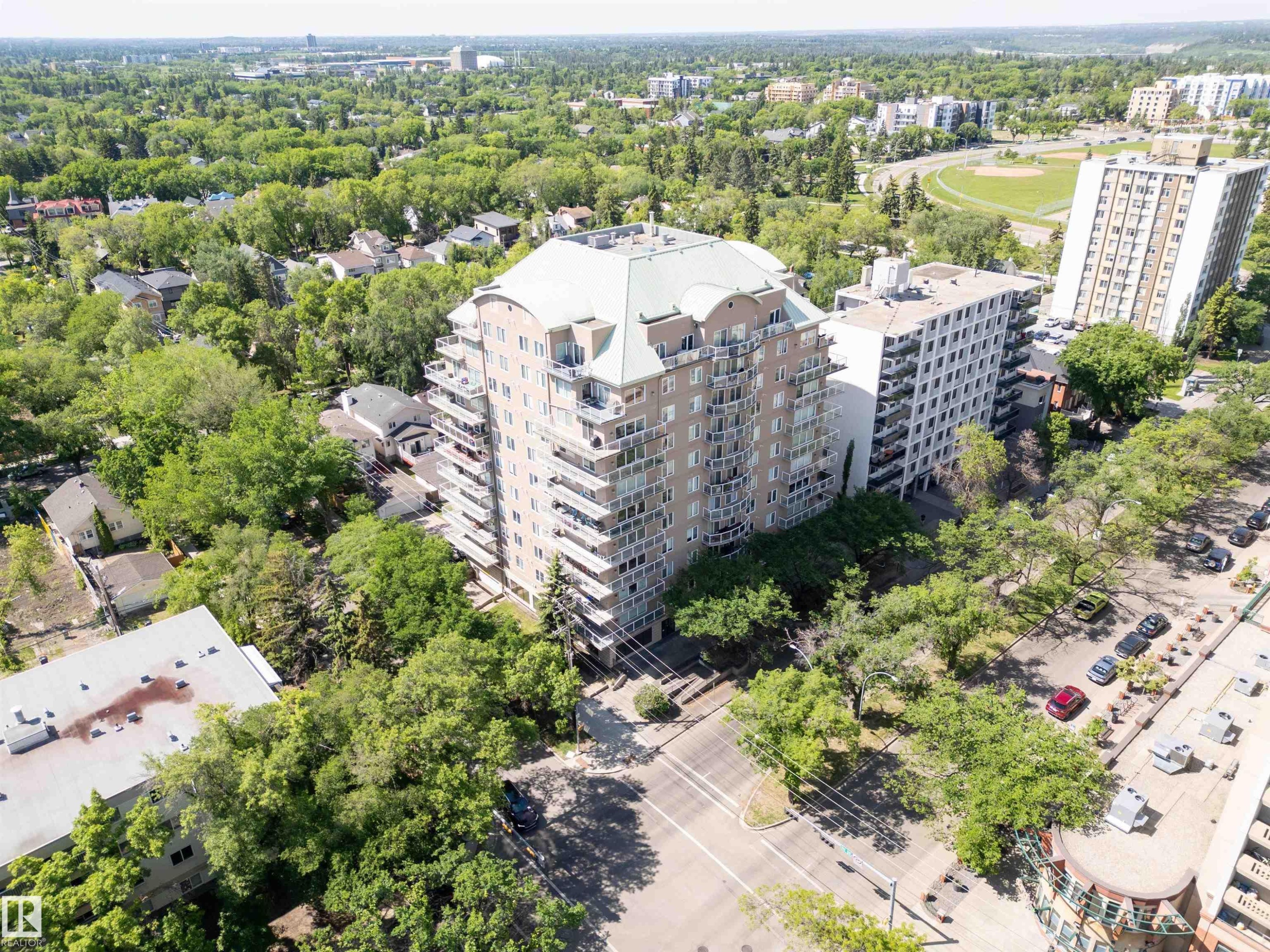 Multi-story building with a light-colored facade, featuring numerous individual balconies - 305 11111 82 Avenue, Edmonton, AB