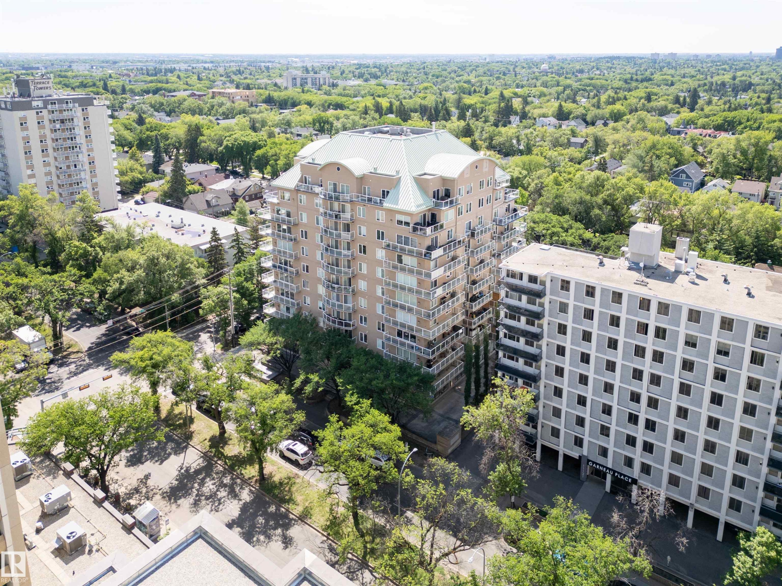 Multi-story residential building featuring a light-toned facade and multiple private balconies - 305 11111 82 Avenue, Edmonton, AB