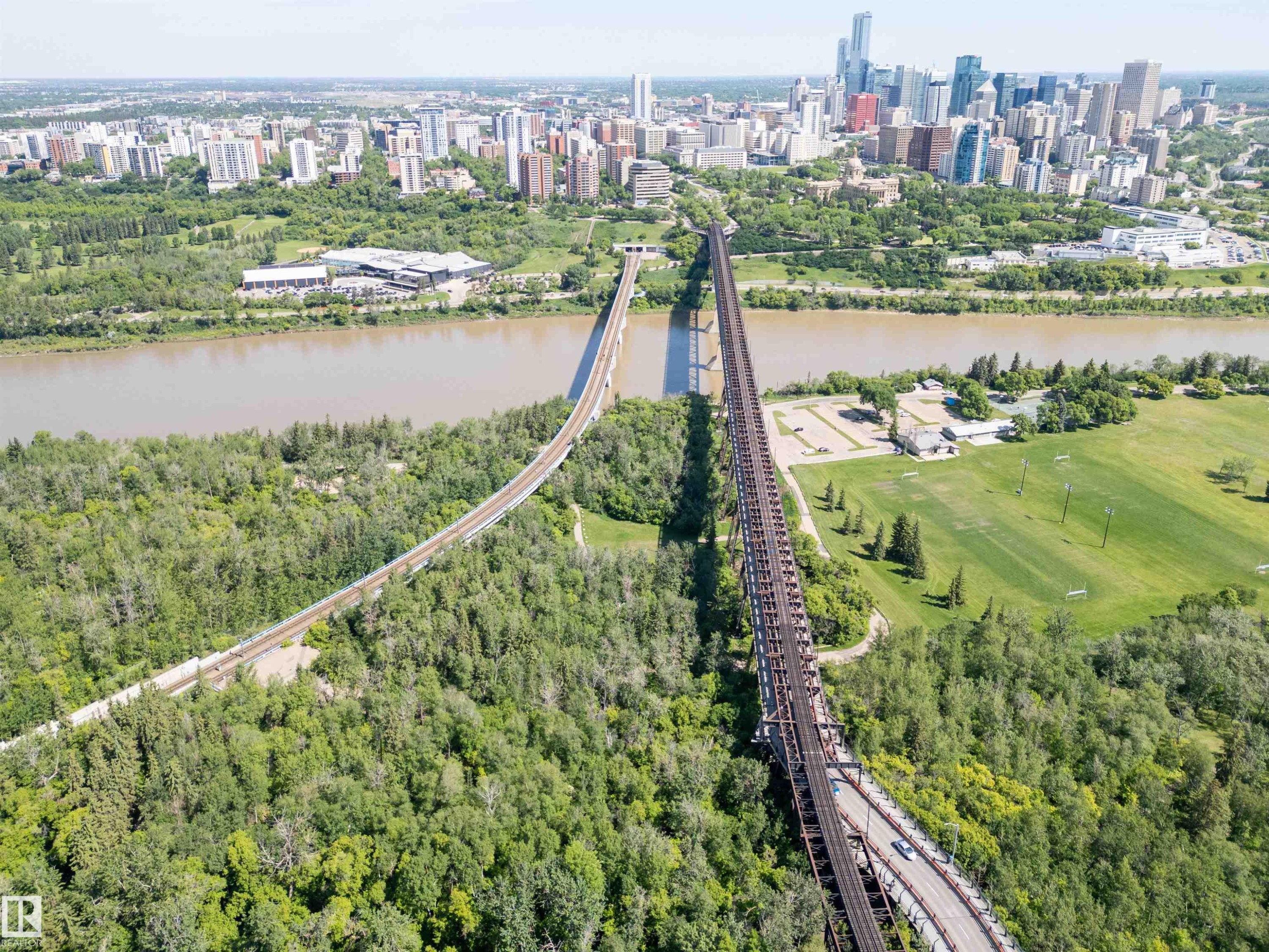 Aerial perspective showcasing a sprawling urban skyline, a wide river, and extensive green spaces - 305 11111 82 Avenue, Edmonton, AB