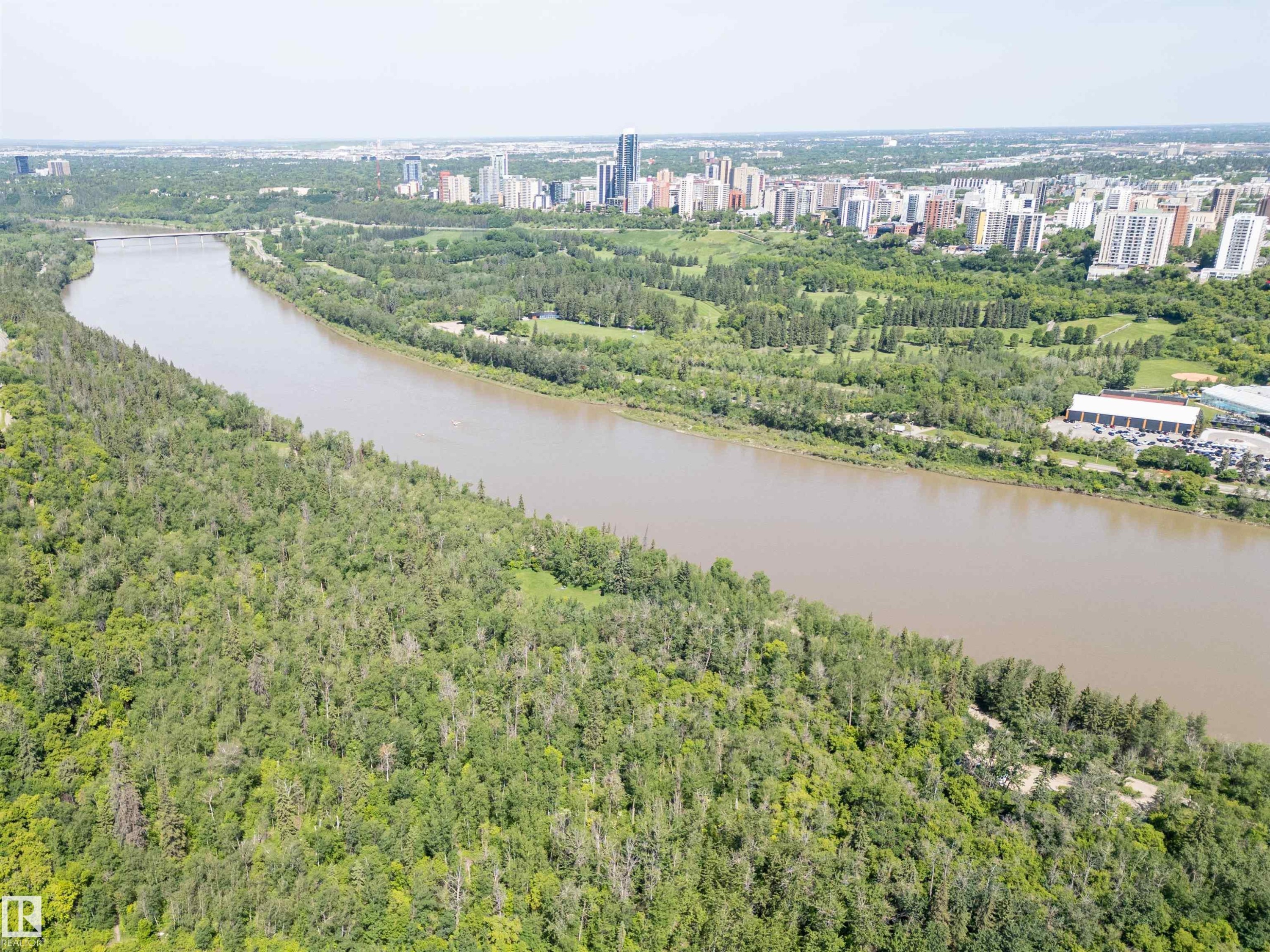 Expansive natural landscape with dense tree coverage bordering a broad river - 305 11111 82 Avenue, Edmonton, AB