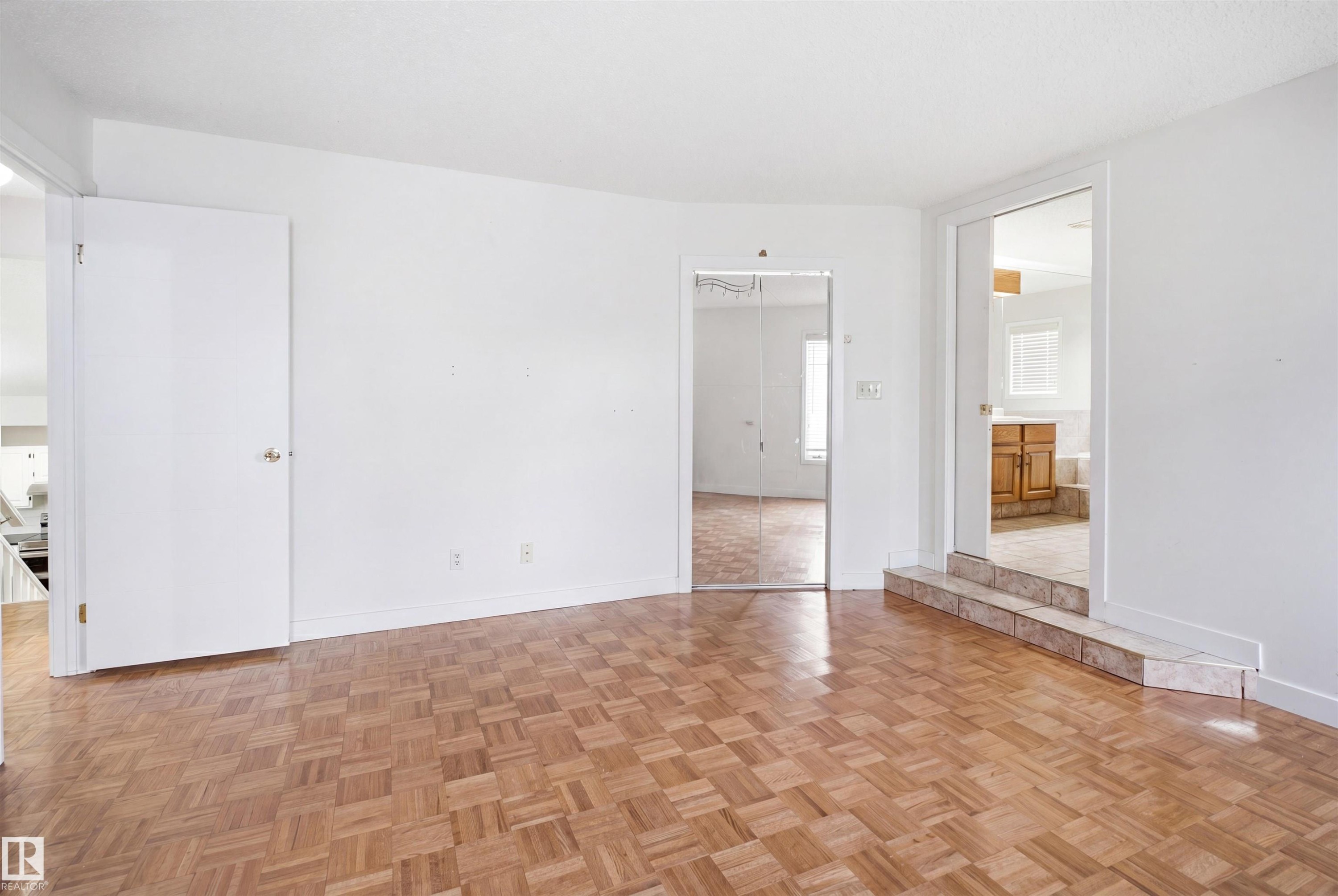 Parquet wood-finish flooring provides a warm foundation for this versatile space - 3220 42A Avenue, Edmonton, AB